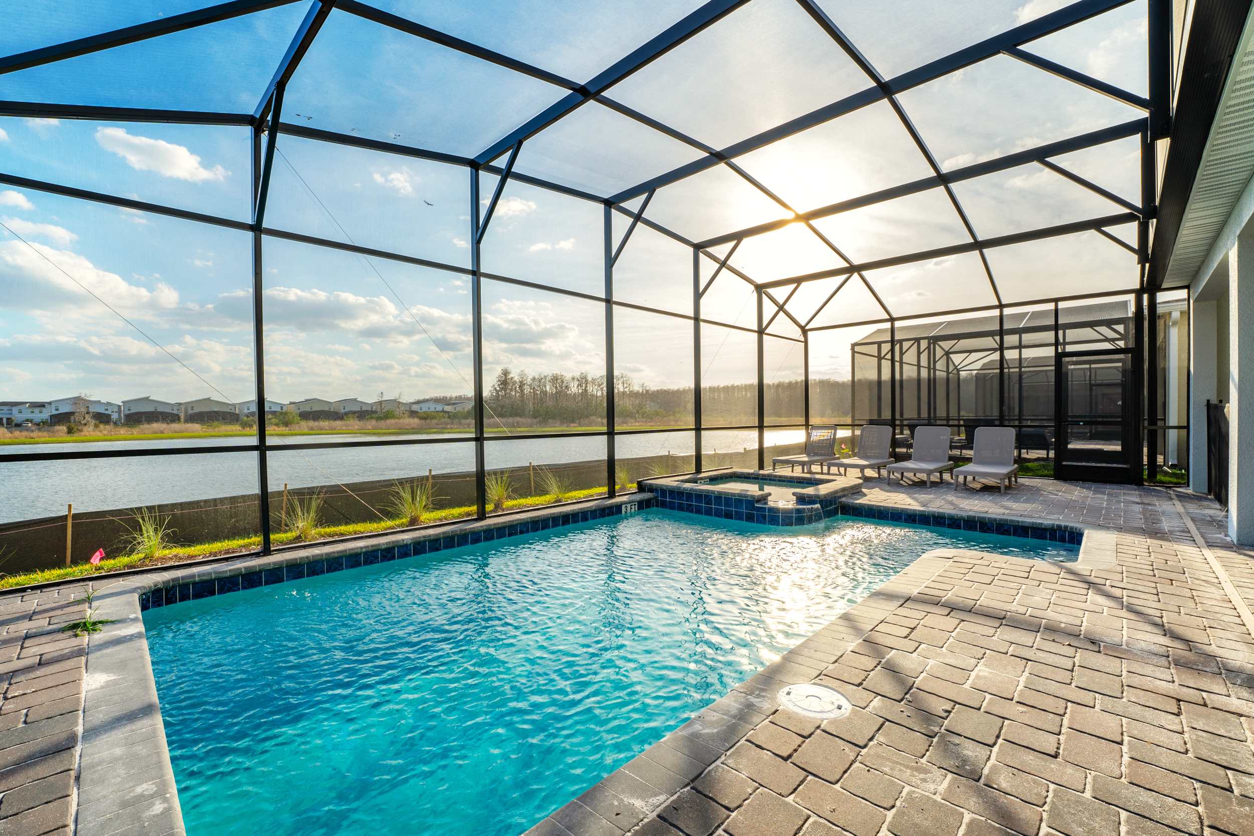Relax in your private screened-in pool with stunning lake views and a soothing hot tub, perfect for unwinding.
