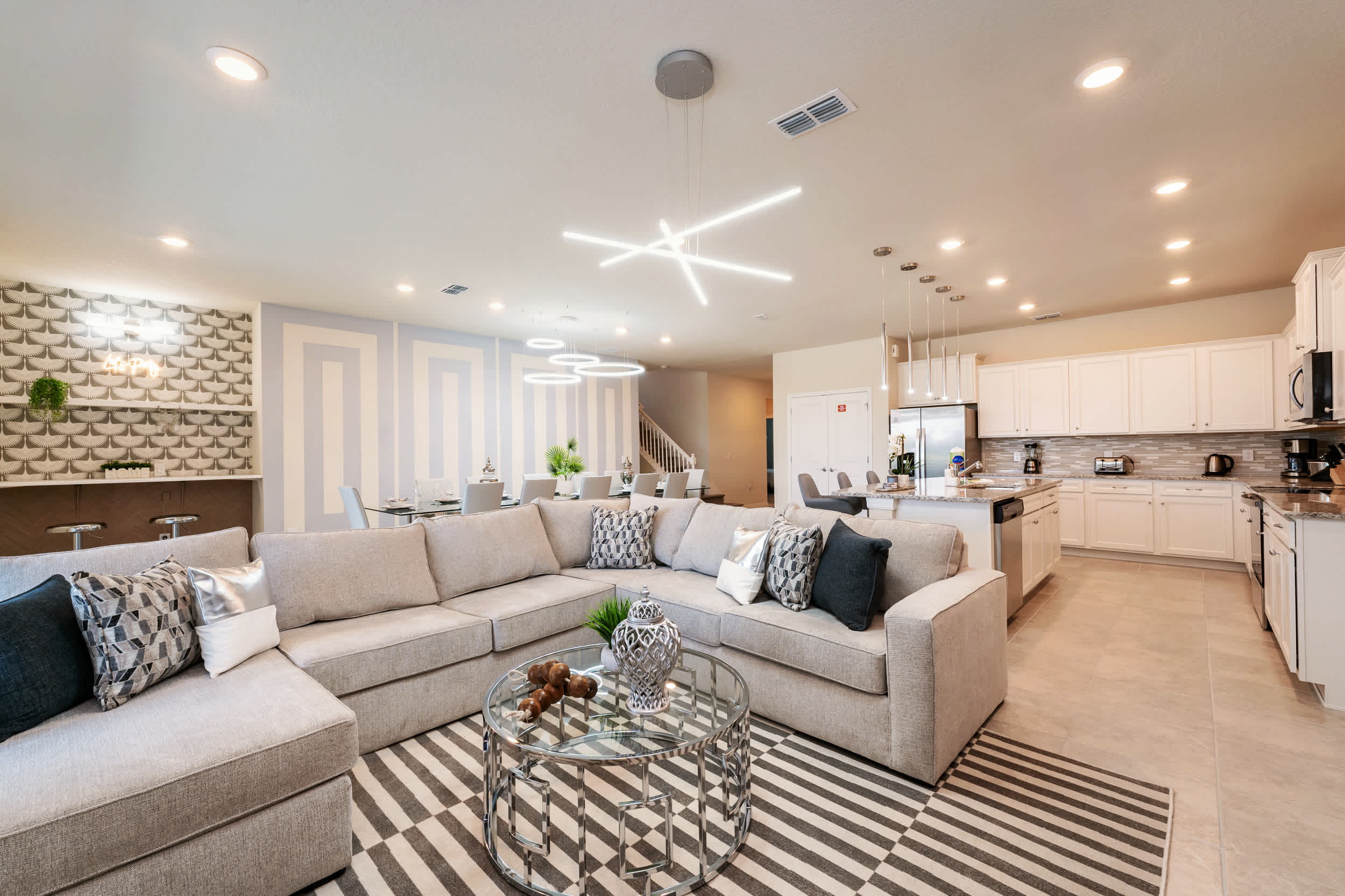Experience luxury in this expansive open-plan living area with modern decor and ample seating, perfect for gatherings.