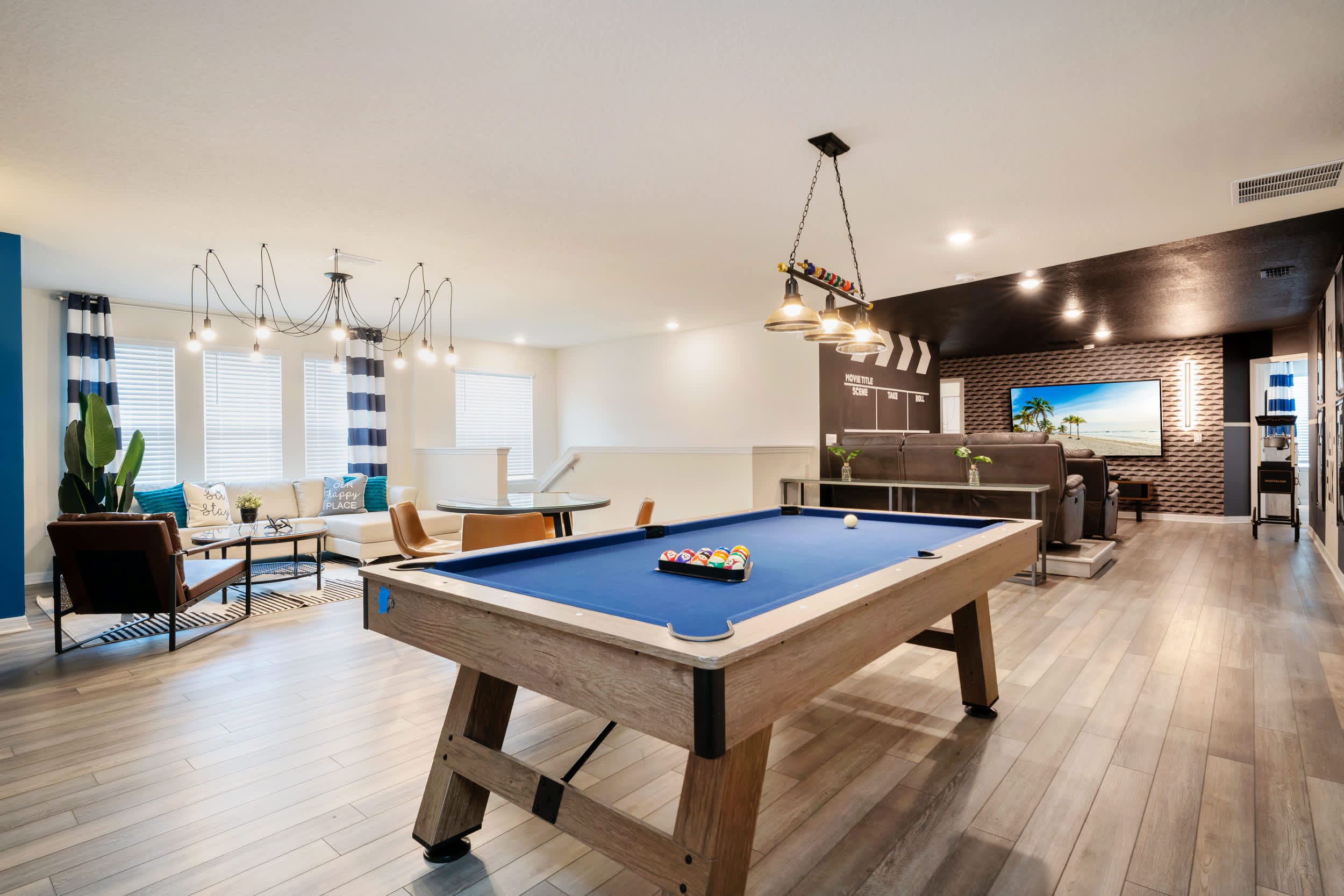 Enjoy endless fun in this stylish game room with a pool table and cozy seating area, perfect for entertaining guests.