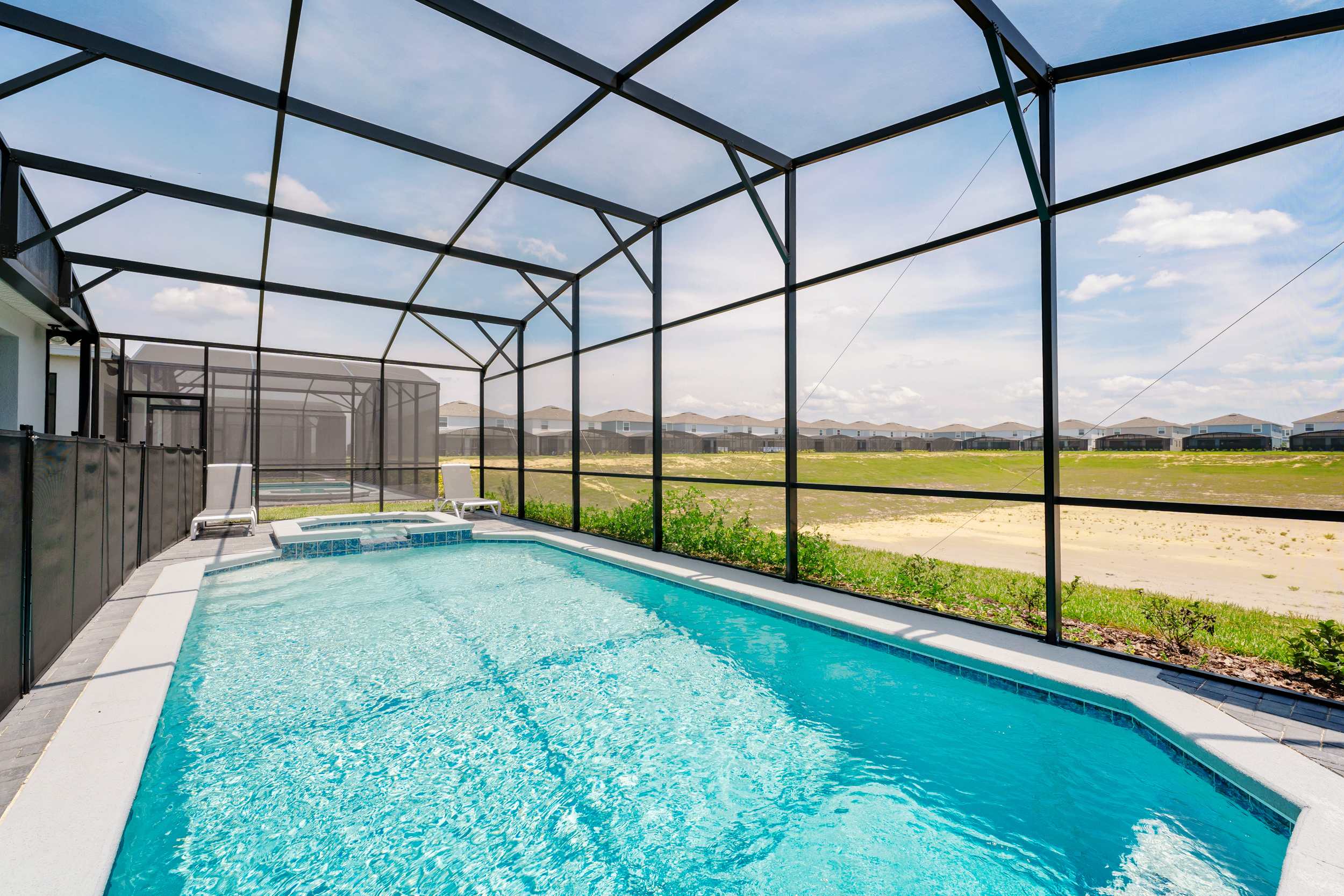 Relax in your private screened pool with serene views and ample lounging space, perfect for unwinding after a day of adventure.