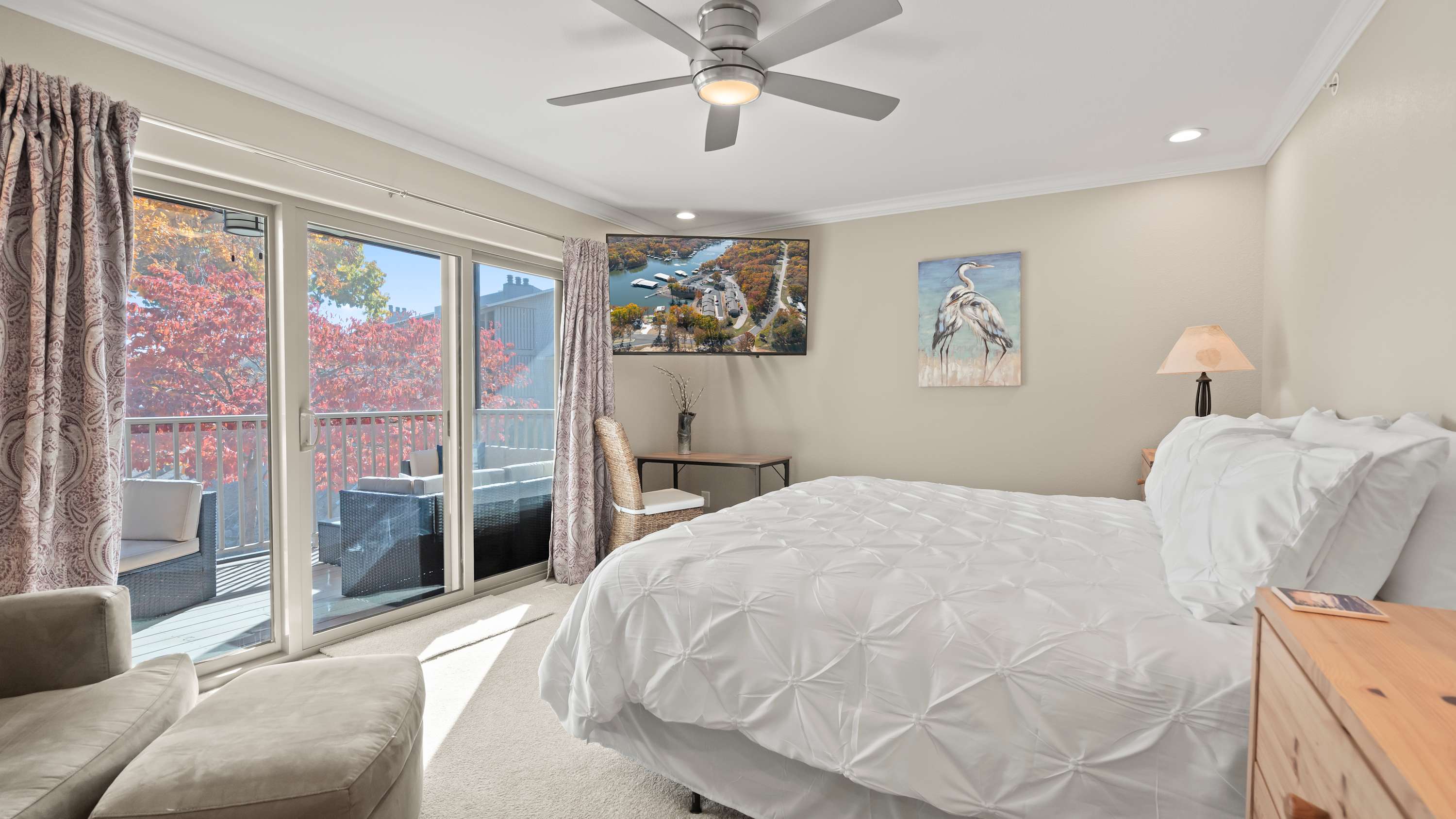 The primary king suite boasts a smart TV, ensuite, & access to the deck​