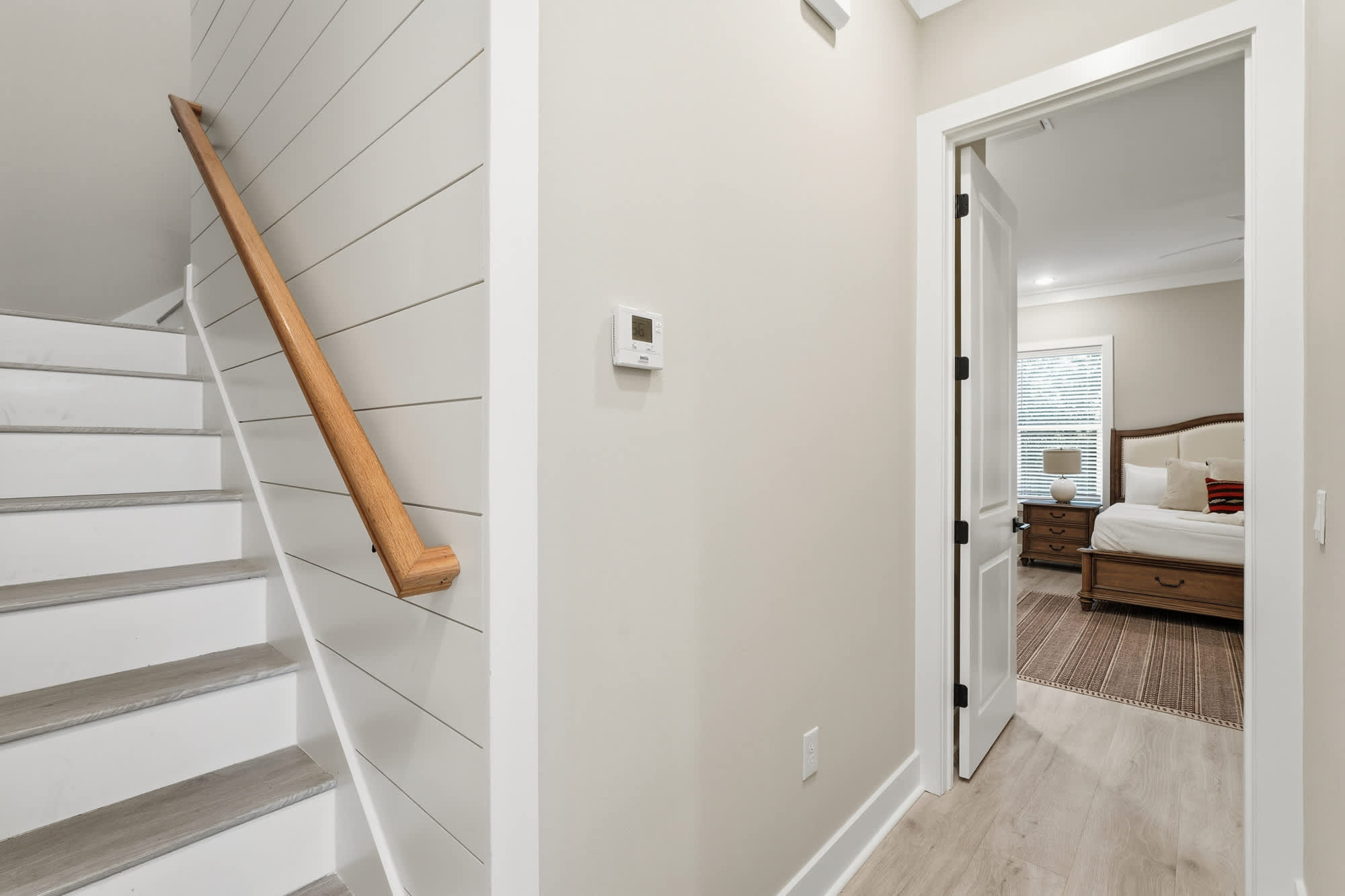 38 W Willow Mist Rd – Staircase leading to a doorway, revealing a bedroom with a bed, nightstands, and window.