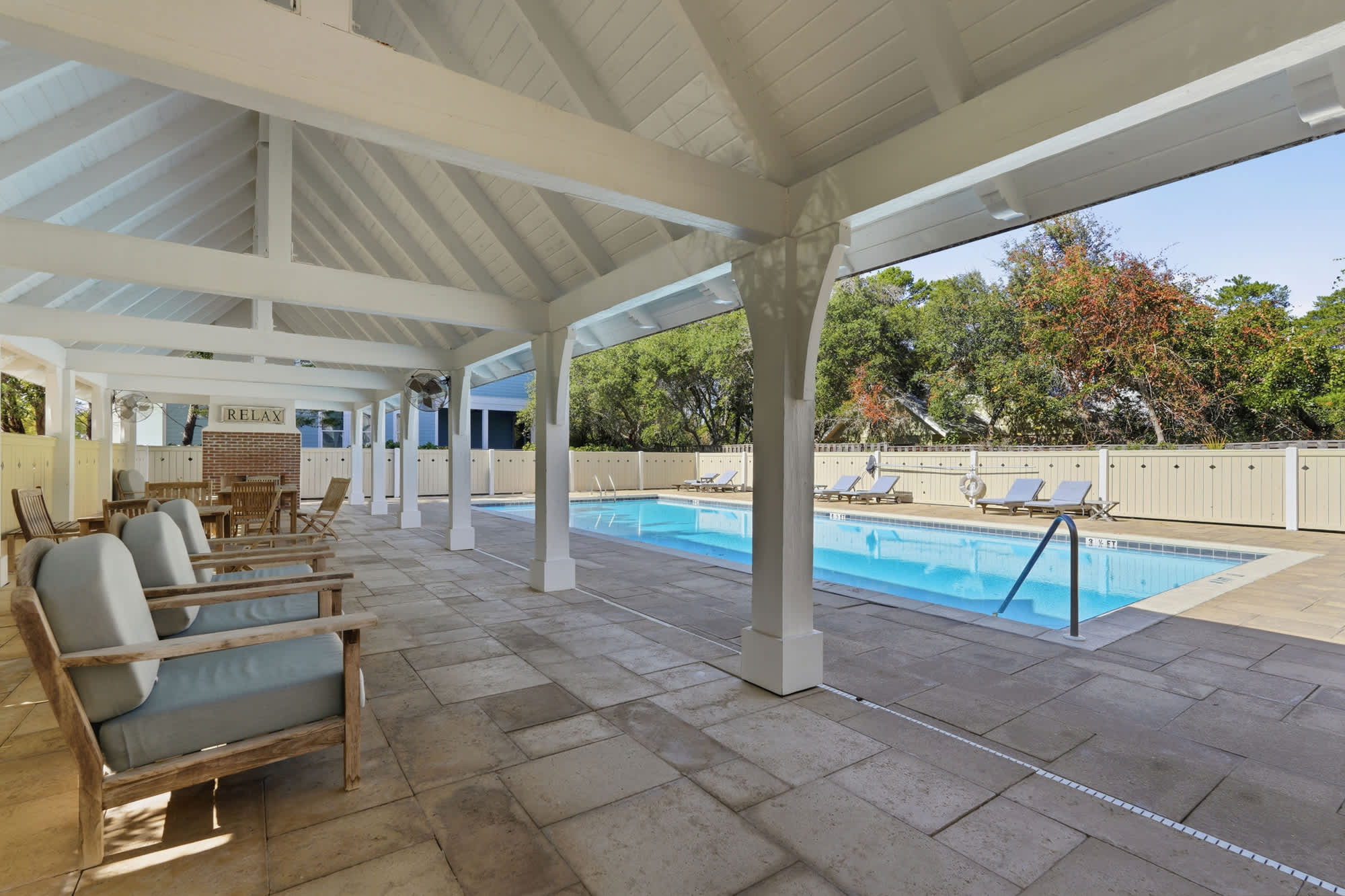 38 W Willow Mist Rd – Covered outdoor seating area with a swimming pool visible in the background.