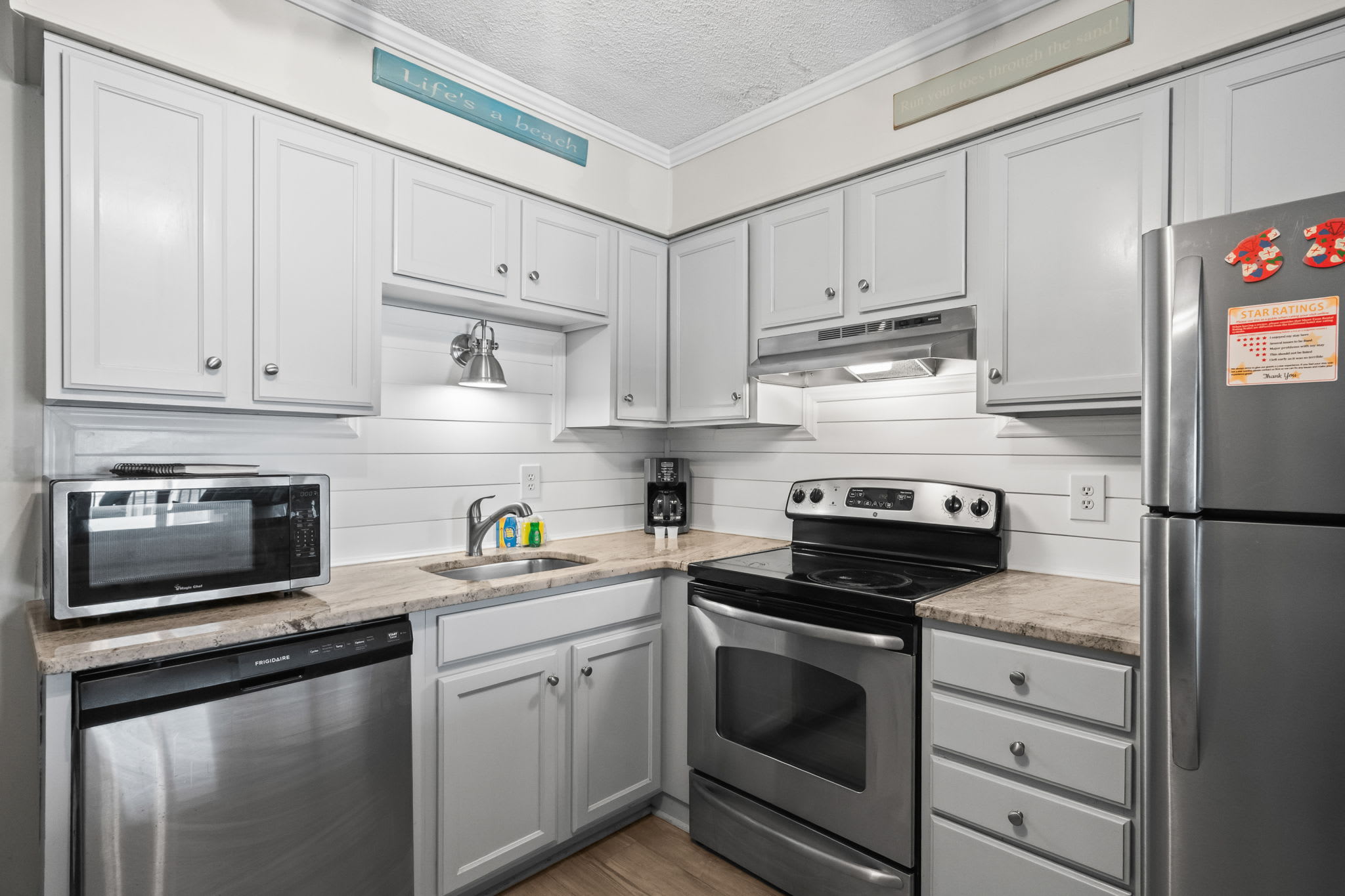 Kitchen with stove, fridge, and more