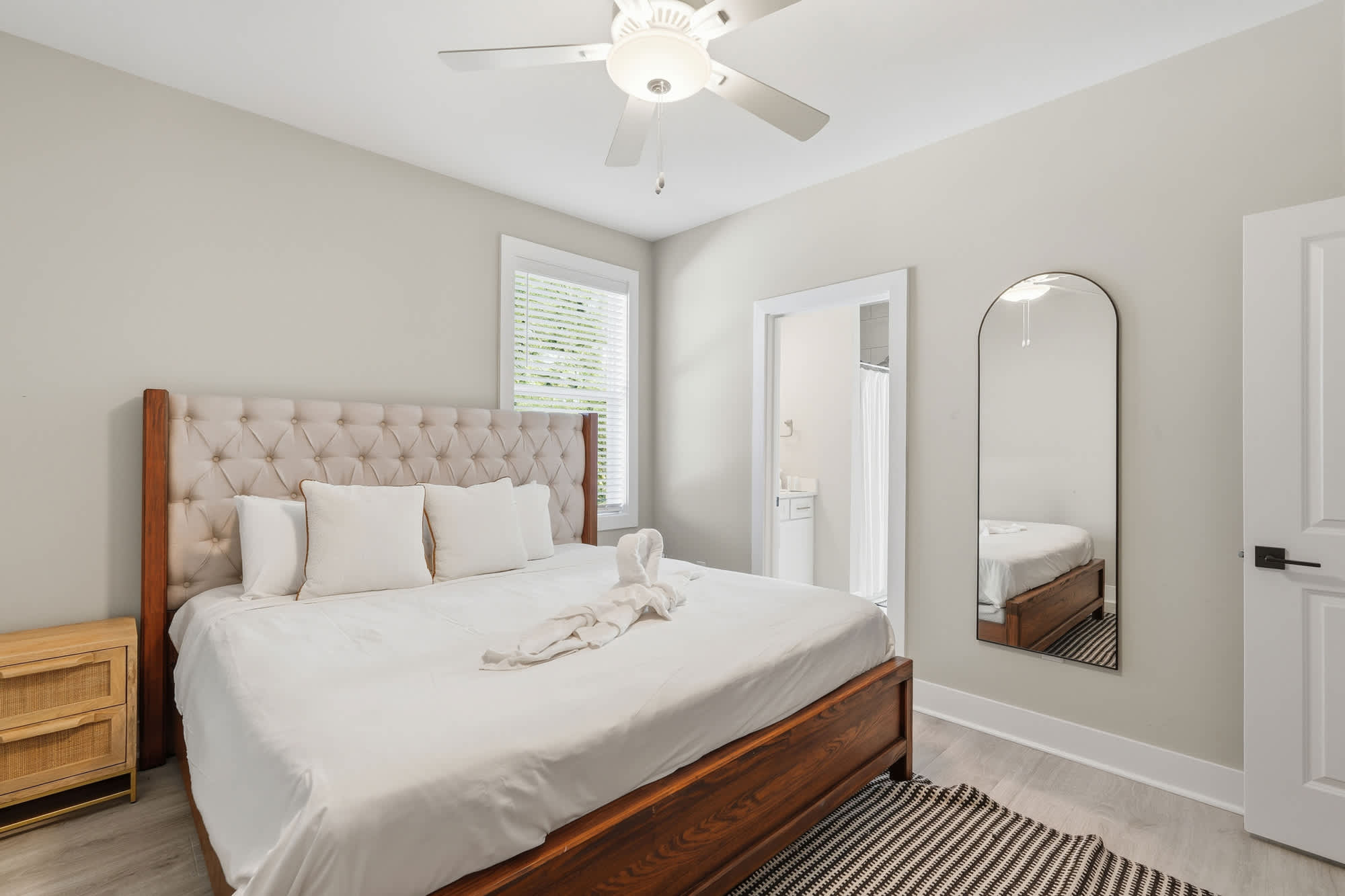 38 W Willow Mist Rd – Cozy bedroom featuring a large bed, mirror, side table, and window with blinds.
