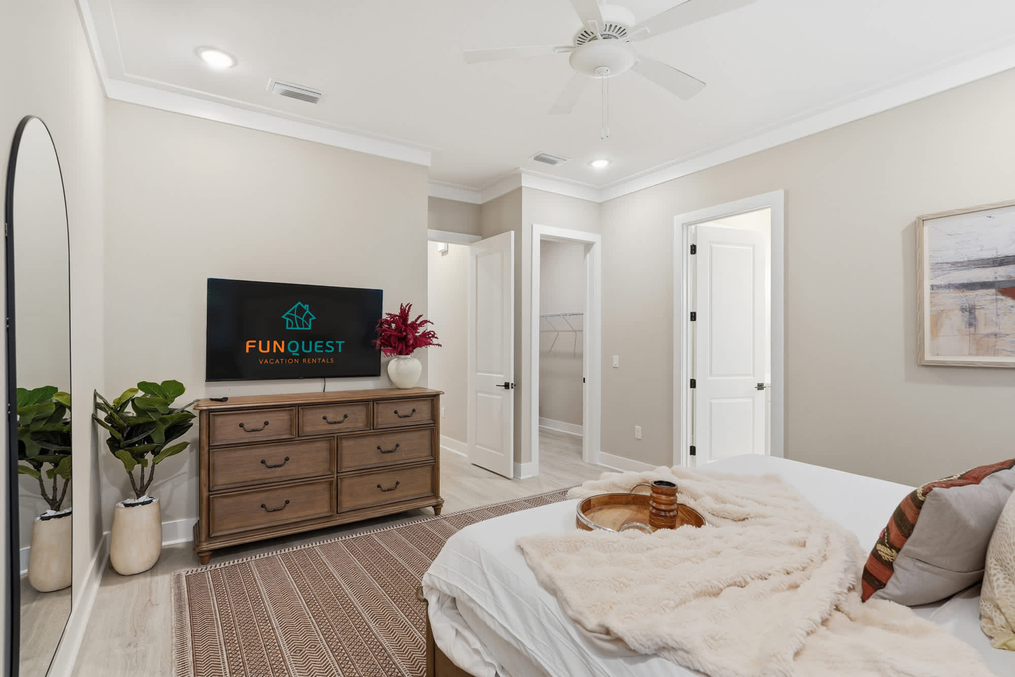 38 W Willow Mist Rd – Cozy bedroom featuring a bed, dresser, TV, plant, and a door leading to a closet.