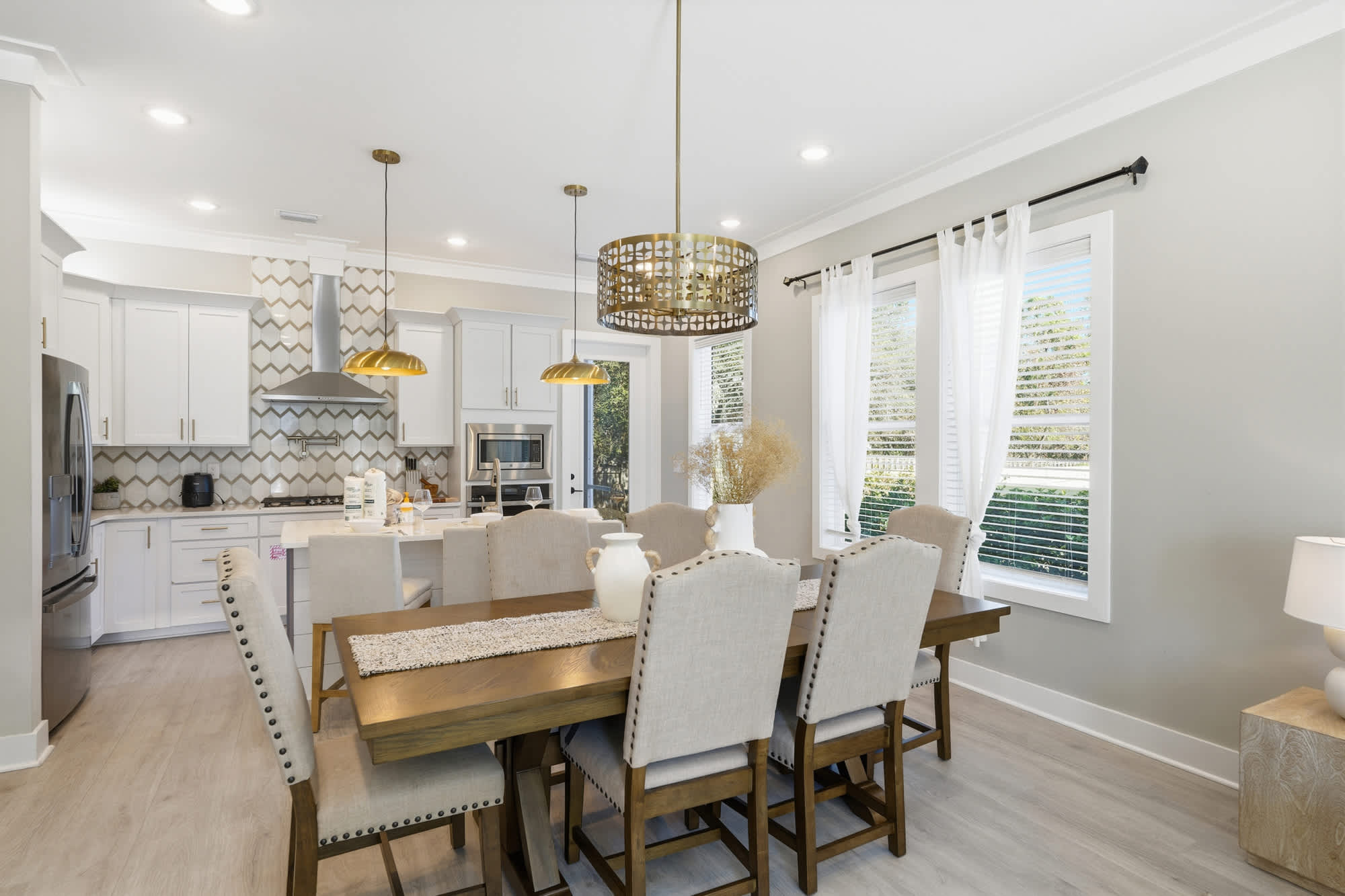 38 W Willow Mist Rd – Bright kitchen and dining area with wooden table, upholstered chairs, and modern appliances.