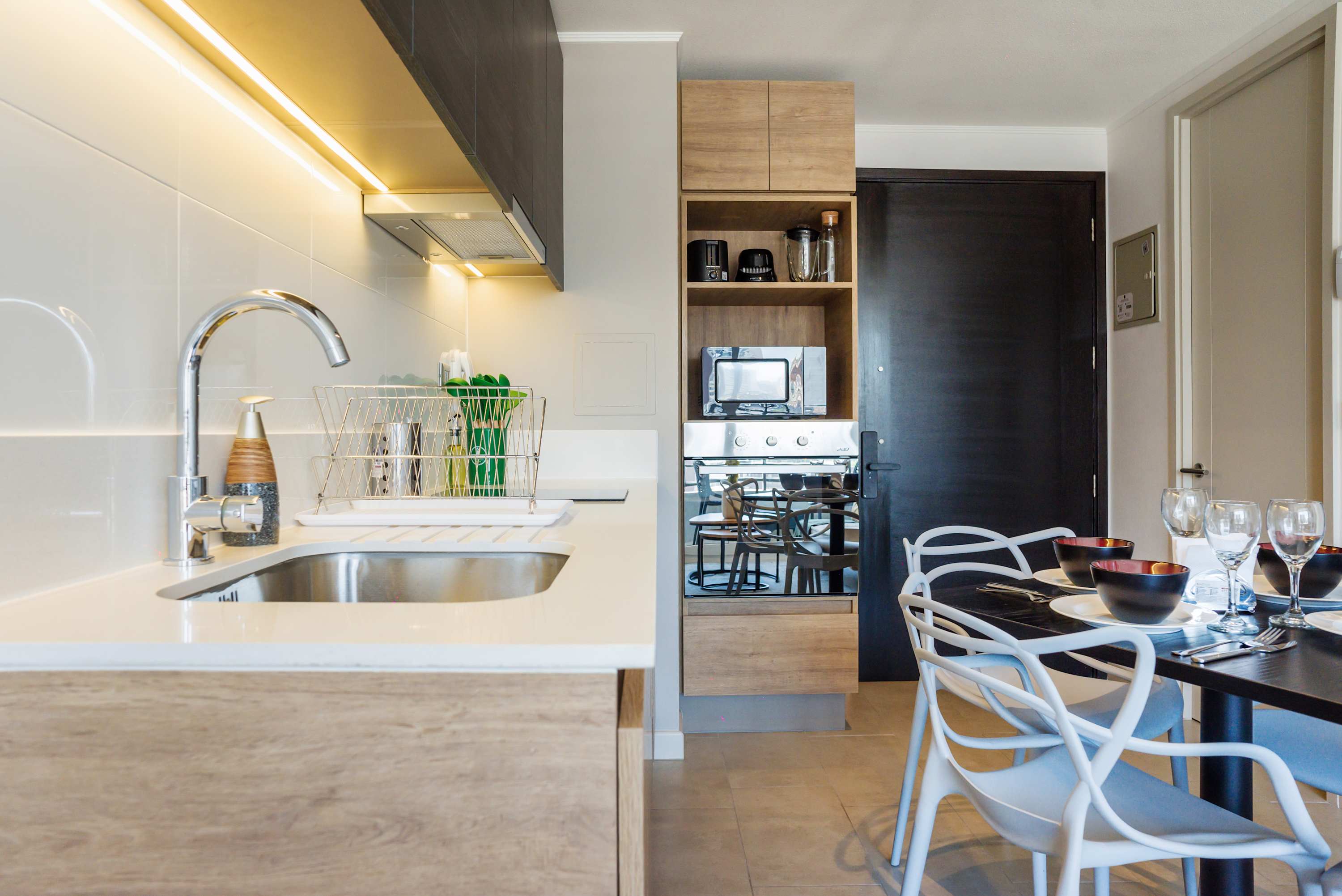 Enjoy cooking in this modern kitchen with sleek appliances and a cozy dining area perfect for intimate meals.