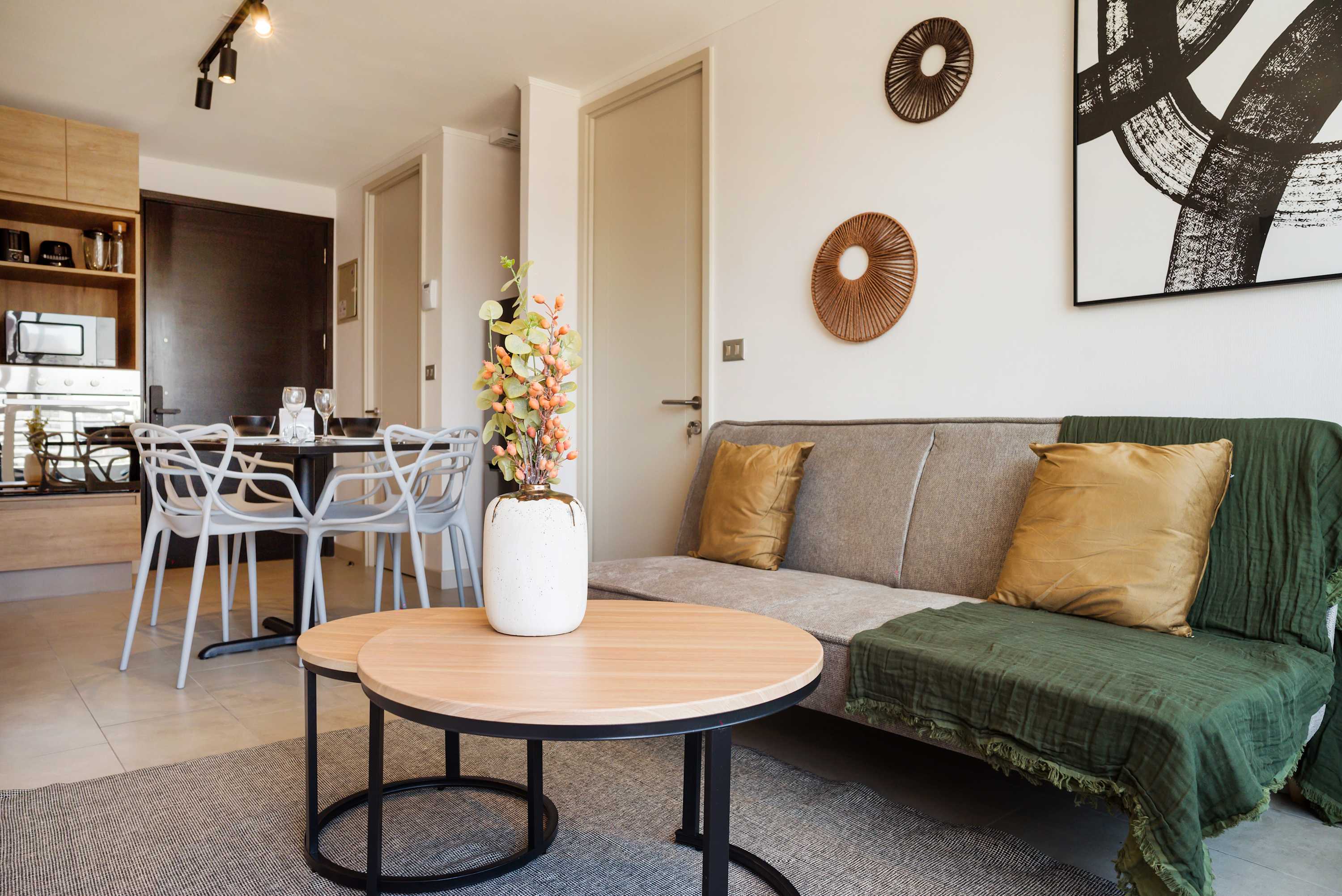 Stylish living area with cozy seating and chic decor, perfect for relaxation and dining.