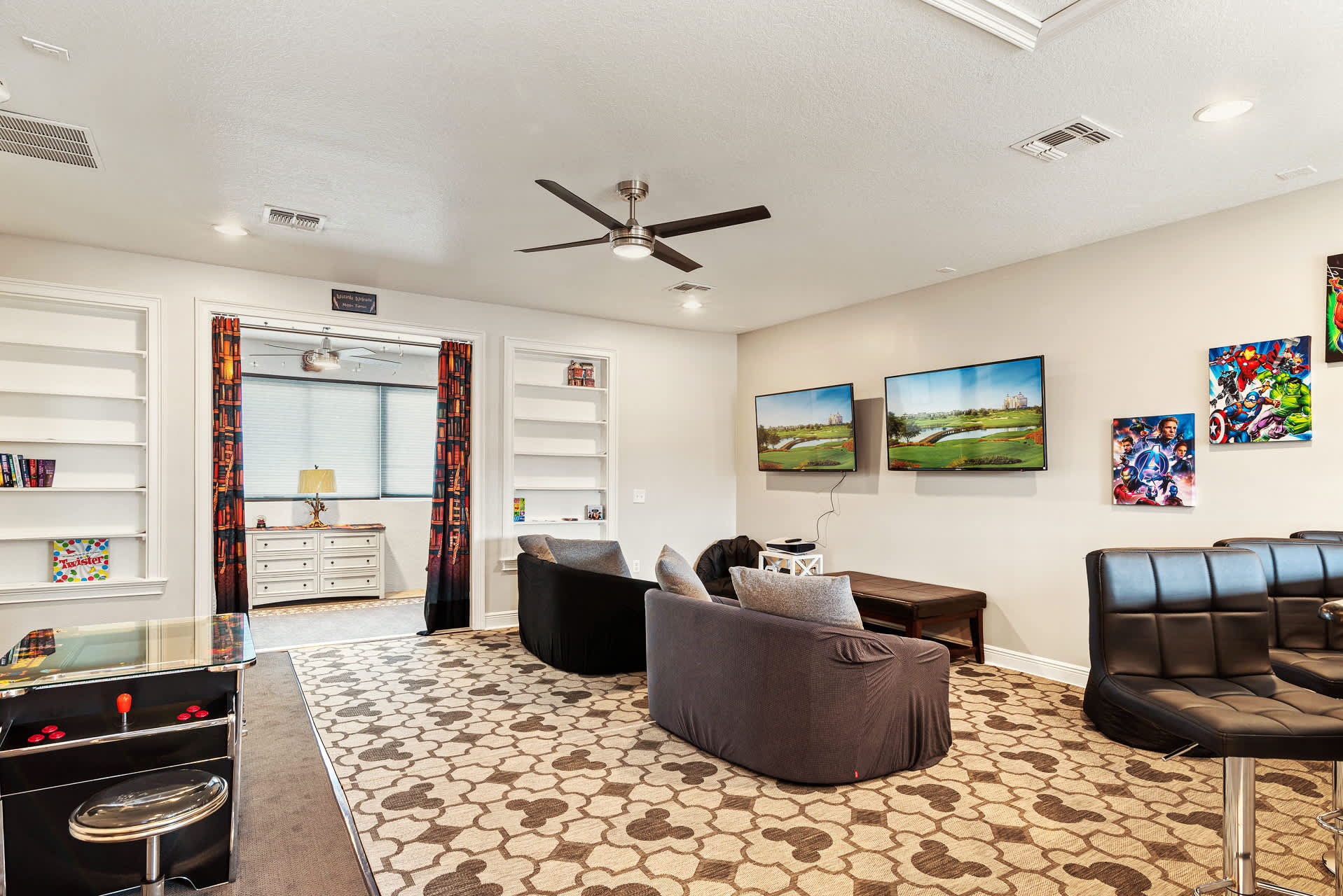 Enjoy gaming and entertainment in this vibrant game room with dual TVs and arcade fun.