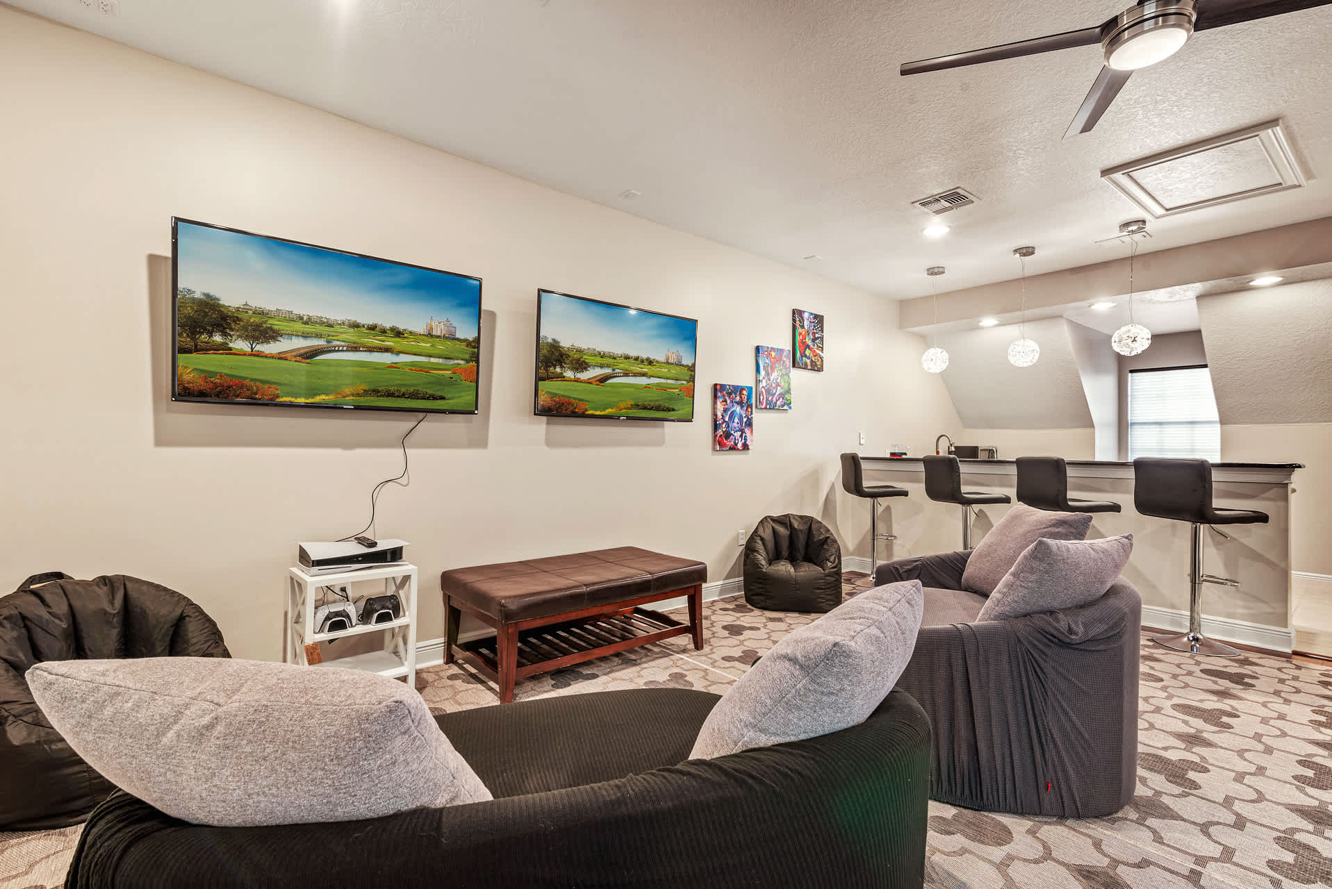 Enjoy movie nights and gaming in this stylish entertainment room with dual TVs and a cozy bar area.