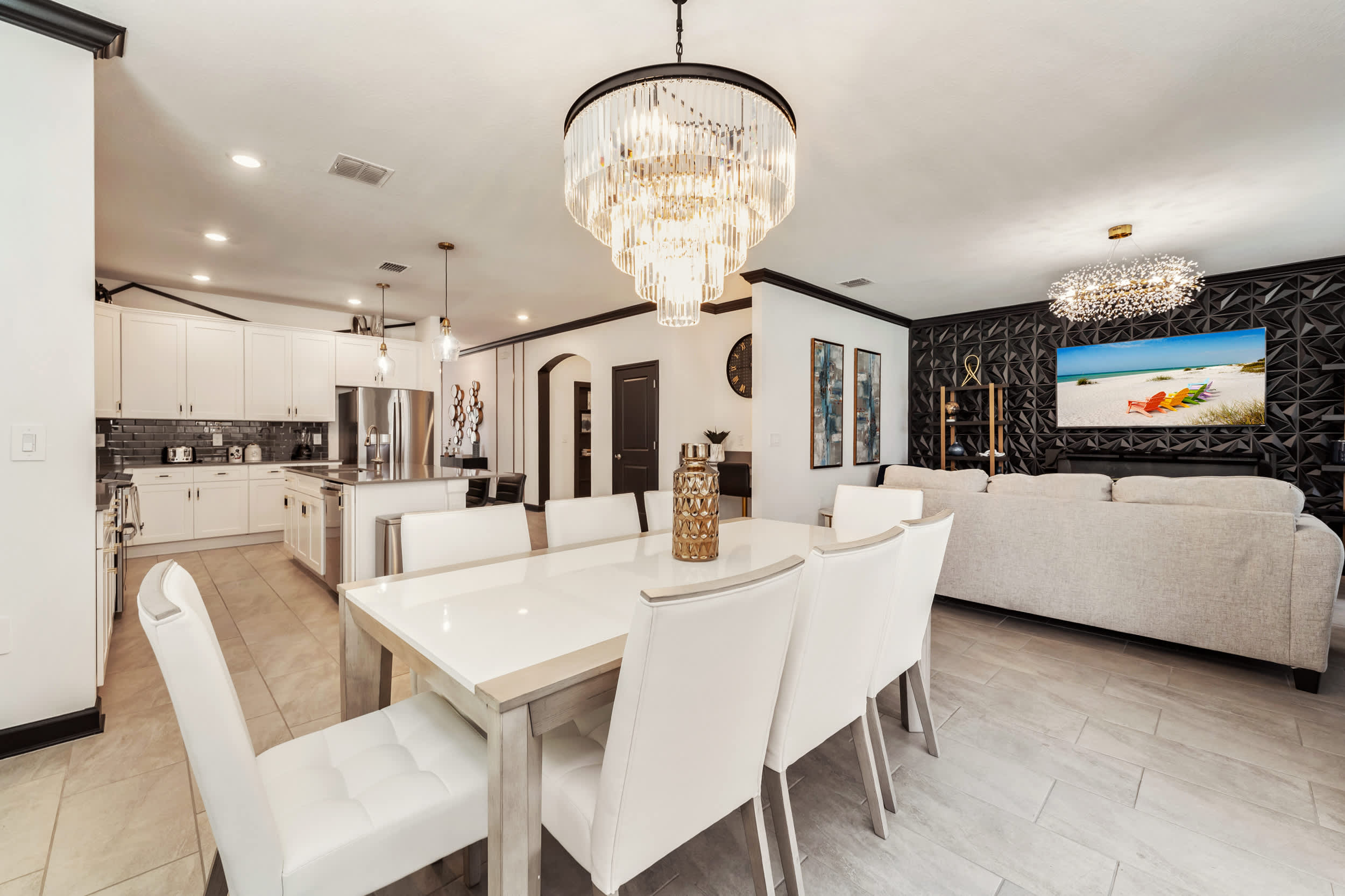 Elegant dining and living space with modern kitchen, perfect for entertaining large groups in style.