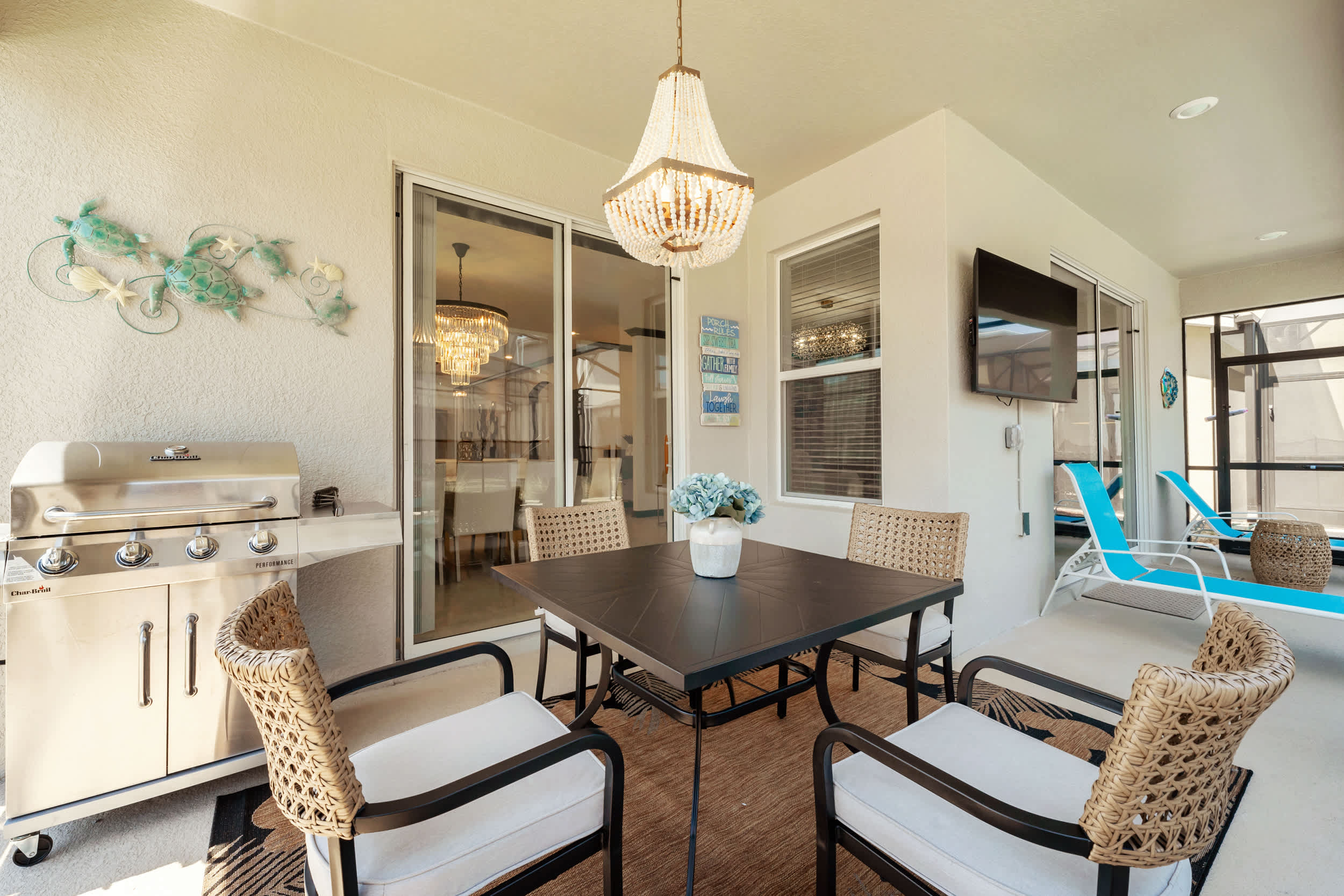 Relax on the stylish patio with a BBQ grill, dining area, and TV—perfect for outdoor gatherings.