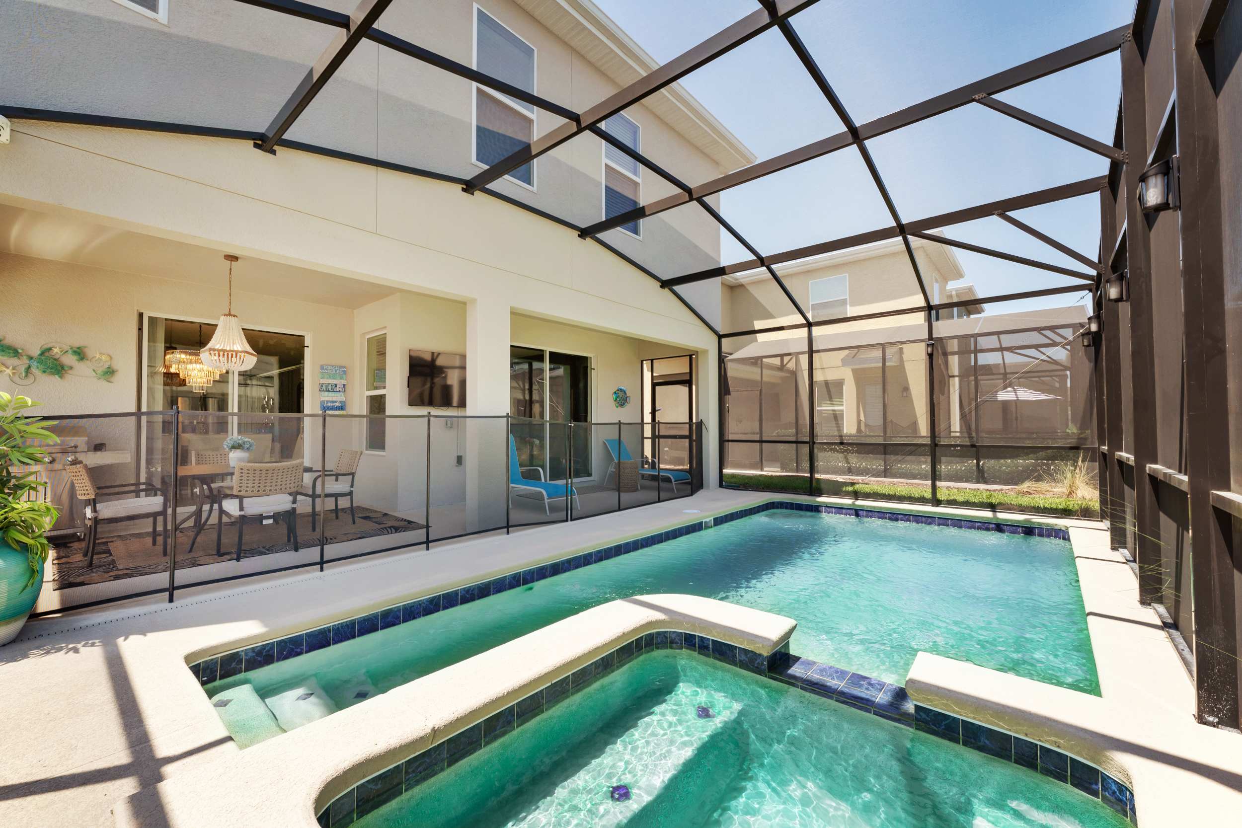 Relax in your private screened-in pool and hot tub, complete with a cozy patio dining area for perfect outdoor gatherings.