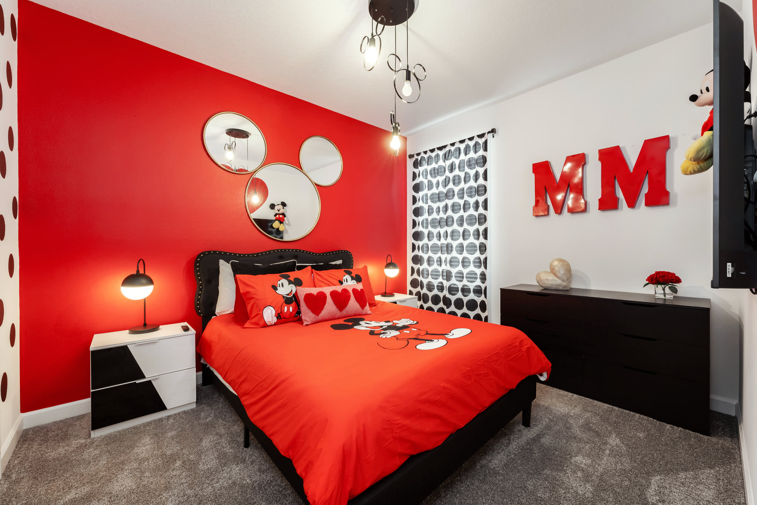 Delight in this vibrant Mickey Mouse-themed bedroom, perfect for kids and Disney fans alike. Enjoy playful decor and cozy bedding for a magical stay.