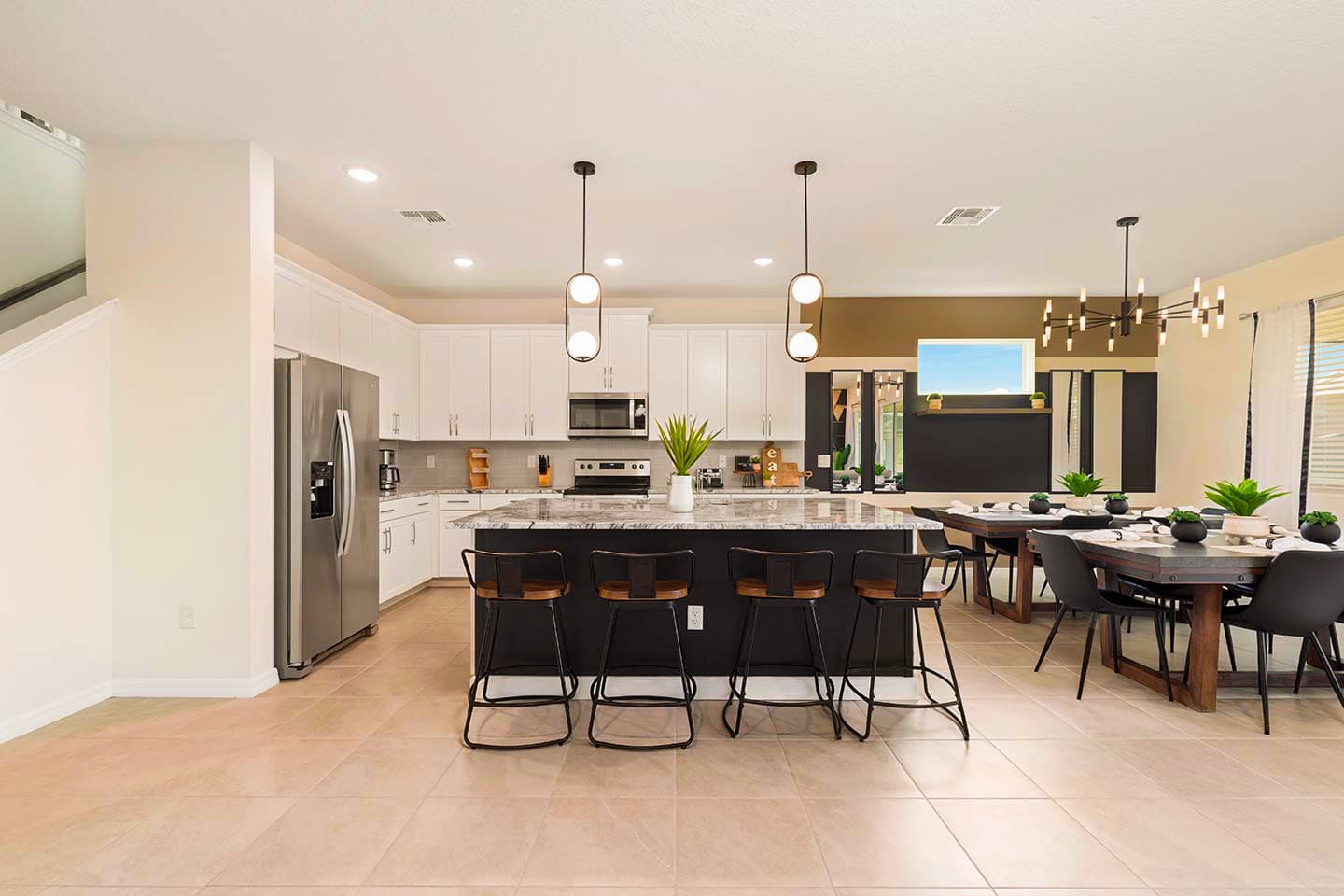 Elegant kitchen and dining area perfect for large gatherings, featuring modern appliances and ample seating.