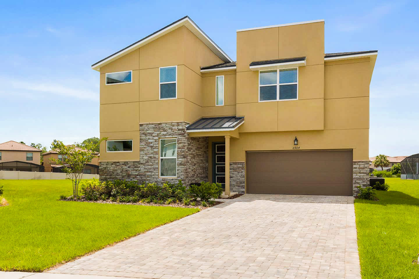 Stunning modern villa with spacious garage and manicured lawn, perfect for large gatherings and family vacations.