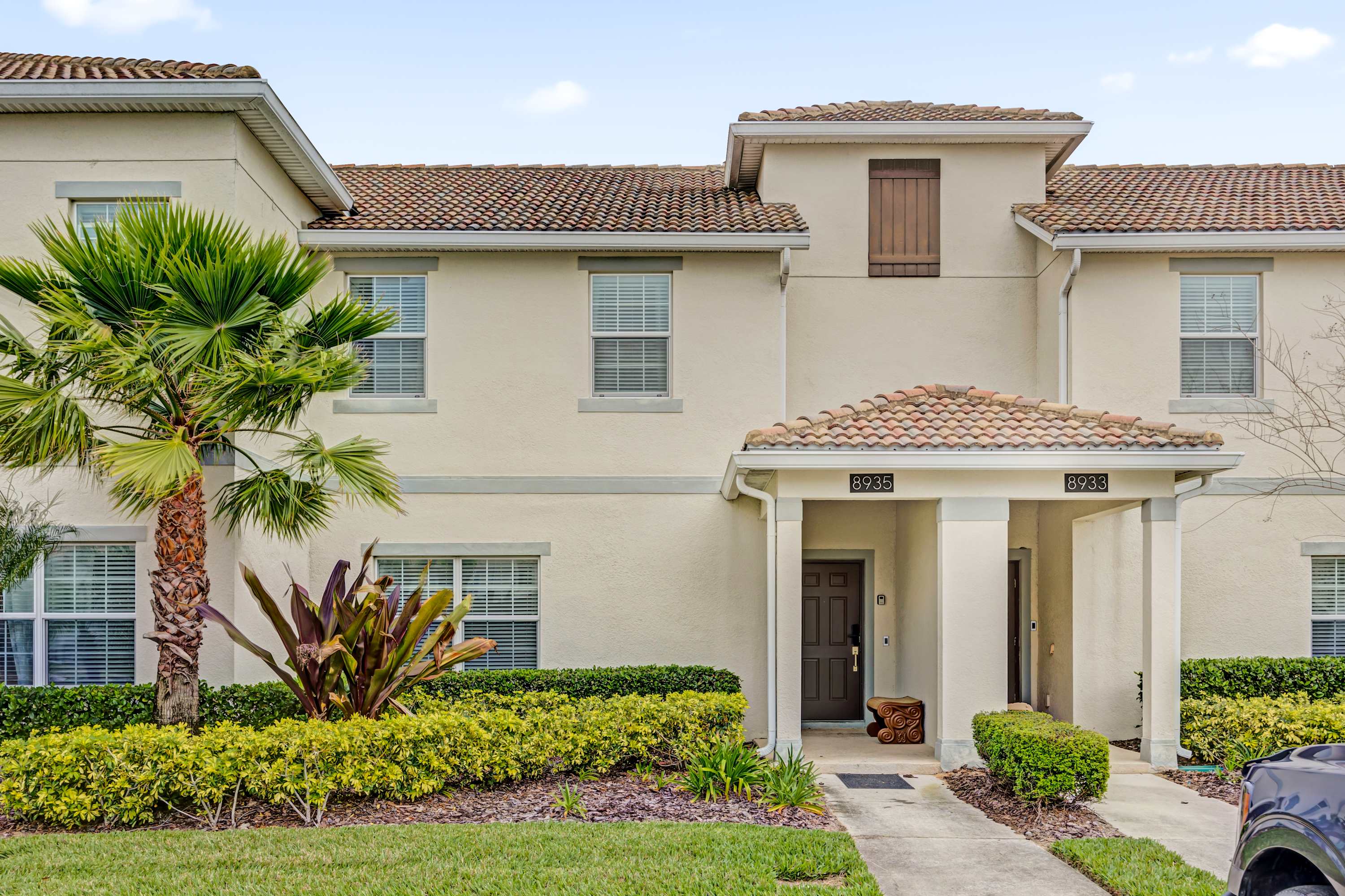 Charming villa with a welcoming entrance and lush landscaping, perfect for a relaxing getaway.