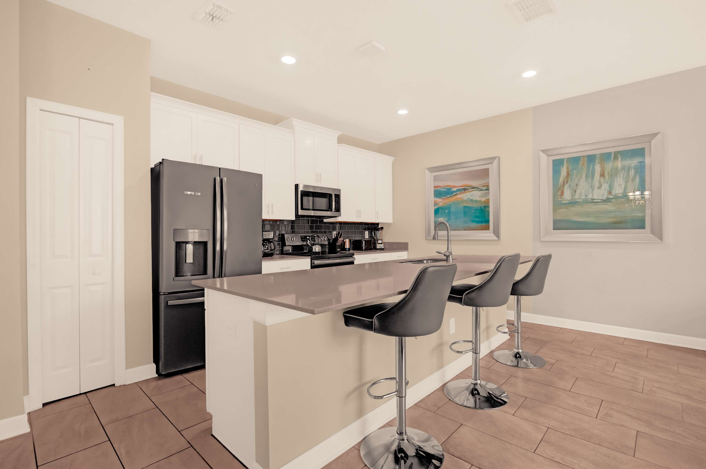 Sleek and modern kitchen with a spacious island, perfect for entertaining and family gatherings.