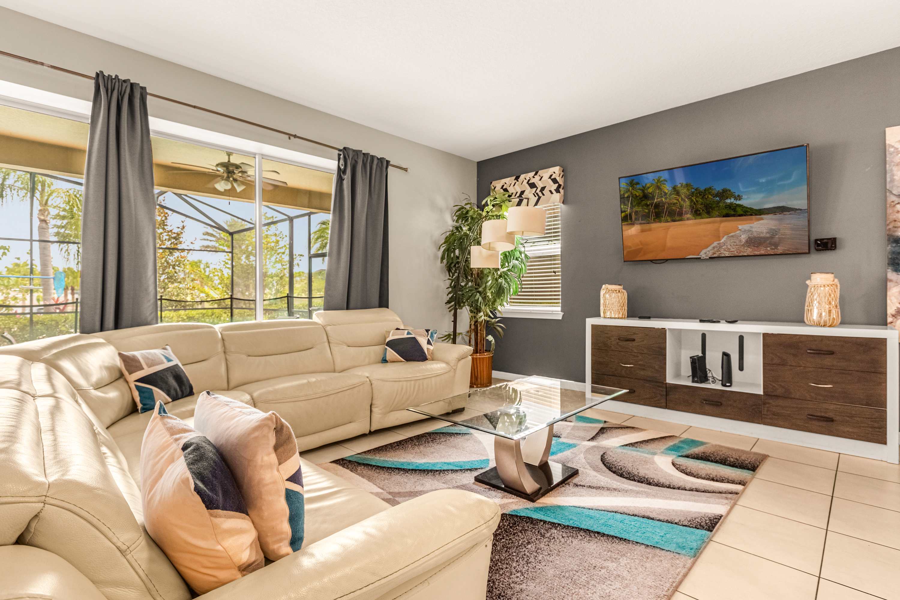 Relax in this stylish living room with a comfy sectional, vibrant decor, and a stunning view of the outdoors.