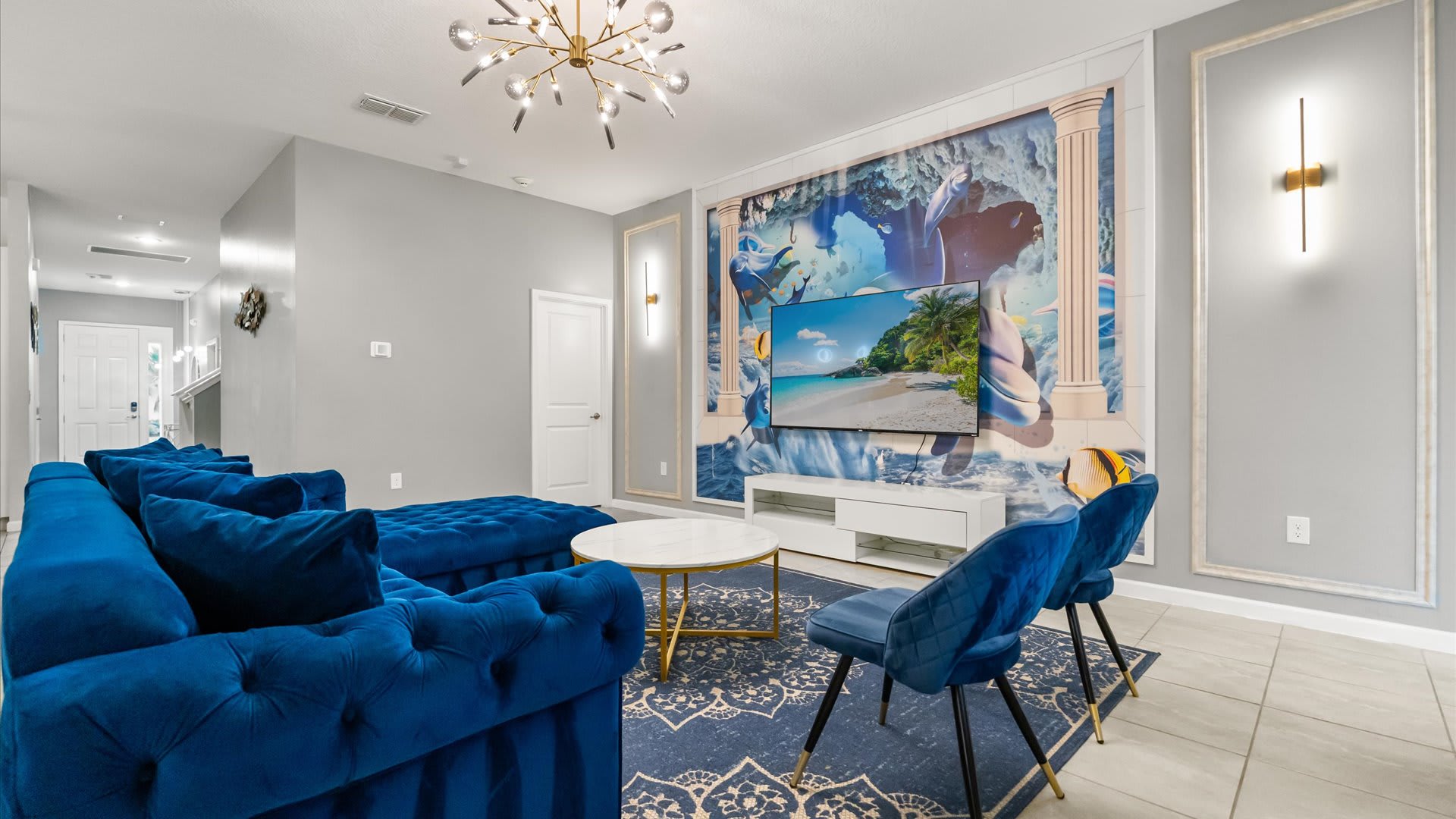 Upscale living room with striking blue seating — perfect for gathering and relaxing together.