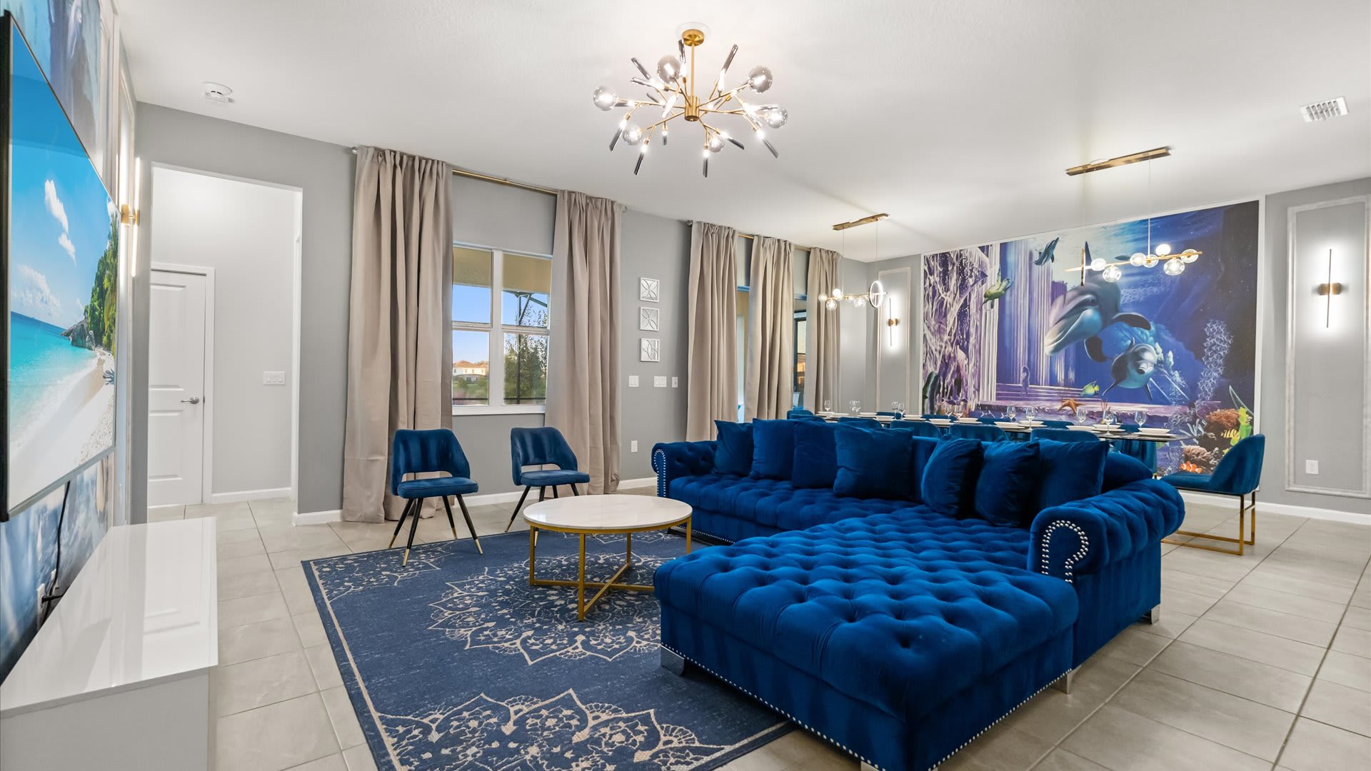 Upscale living room with striking blue seating — perfect for gathering and relaxing together.