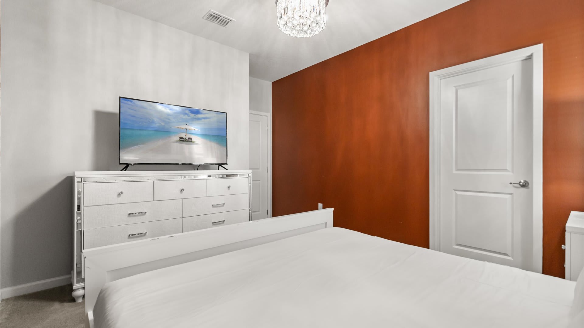 Bedroom 7 – Spacious king suite with warm accents and calming lighting.