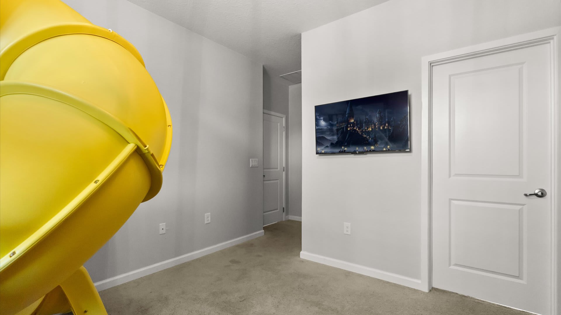 Kids’ adventure bedroom with indoor slide and climbing features — endless fun in a safe space.