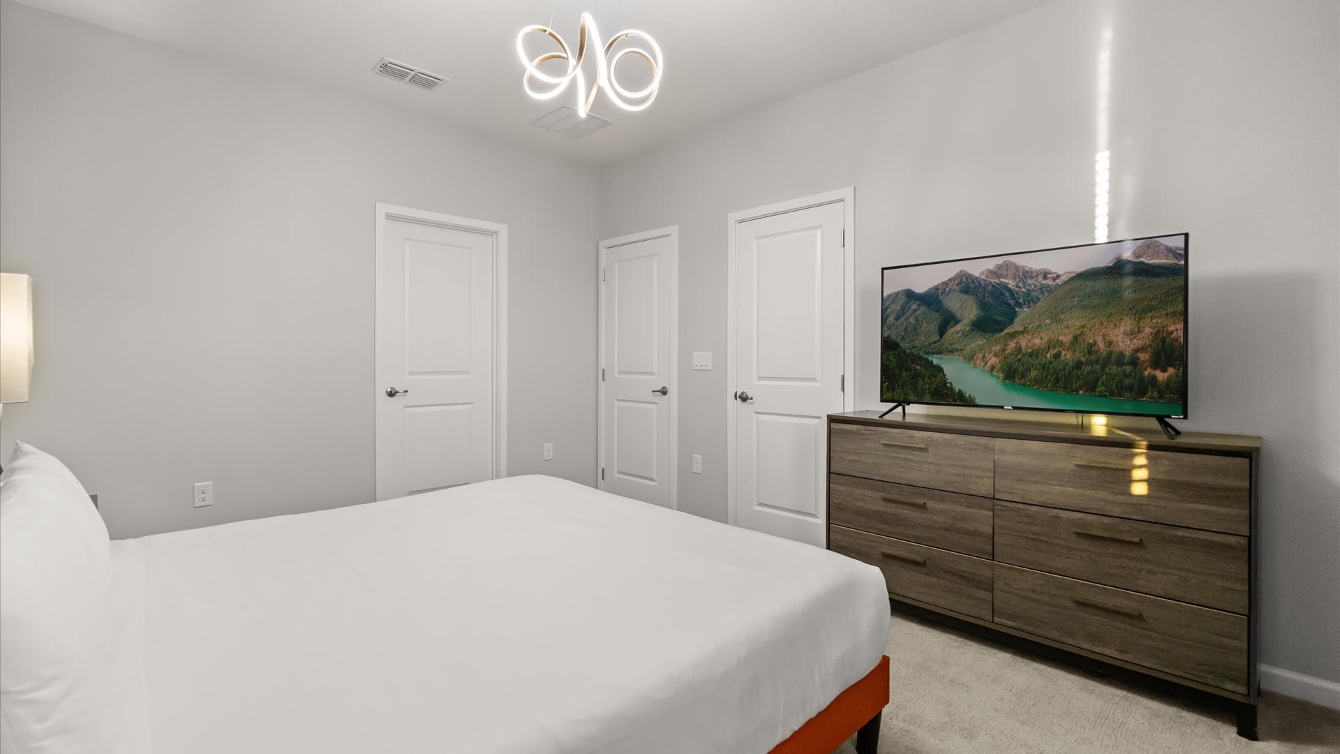Bedroom 12 – Stylish king suite with vibrant wall art and cozy ambience.