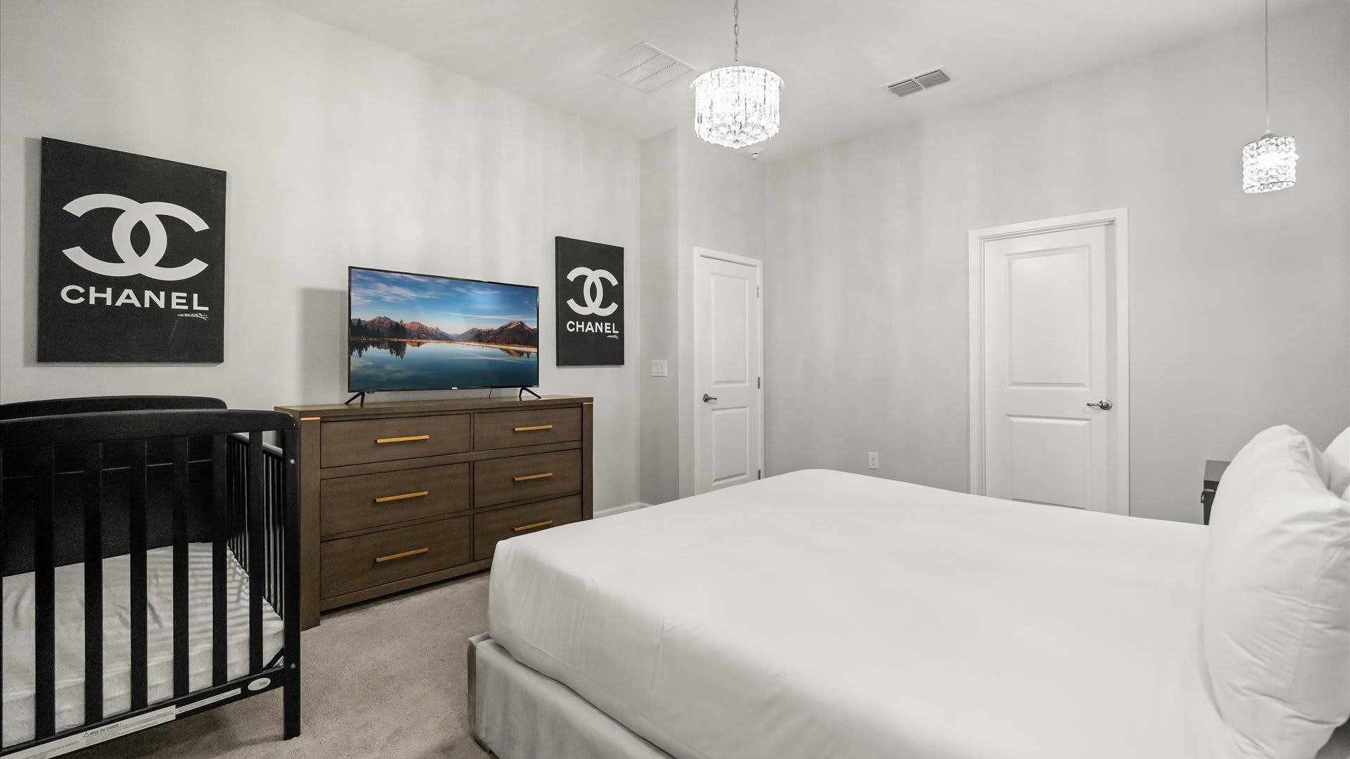 Bedroom 4 – Contemporary king room with geometric wall design and blackout curtains.