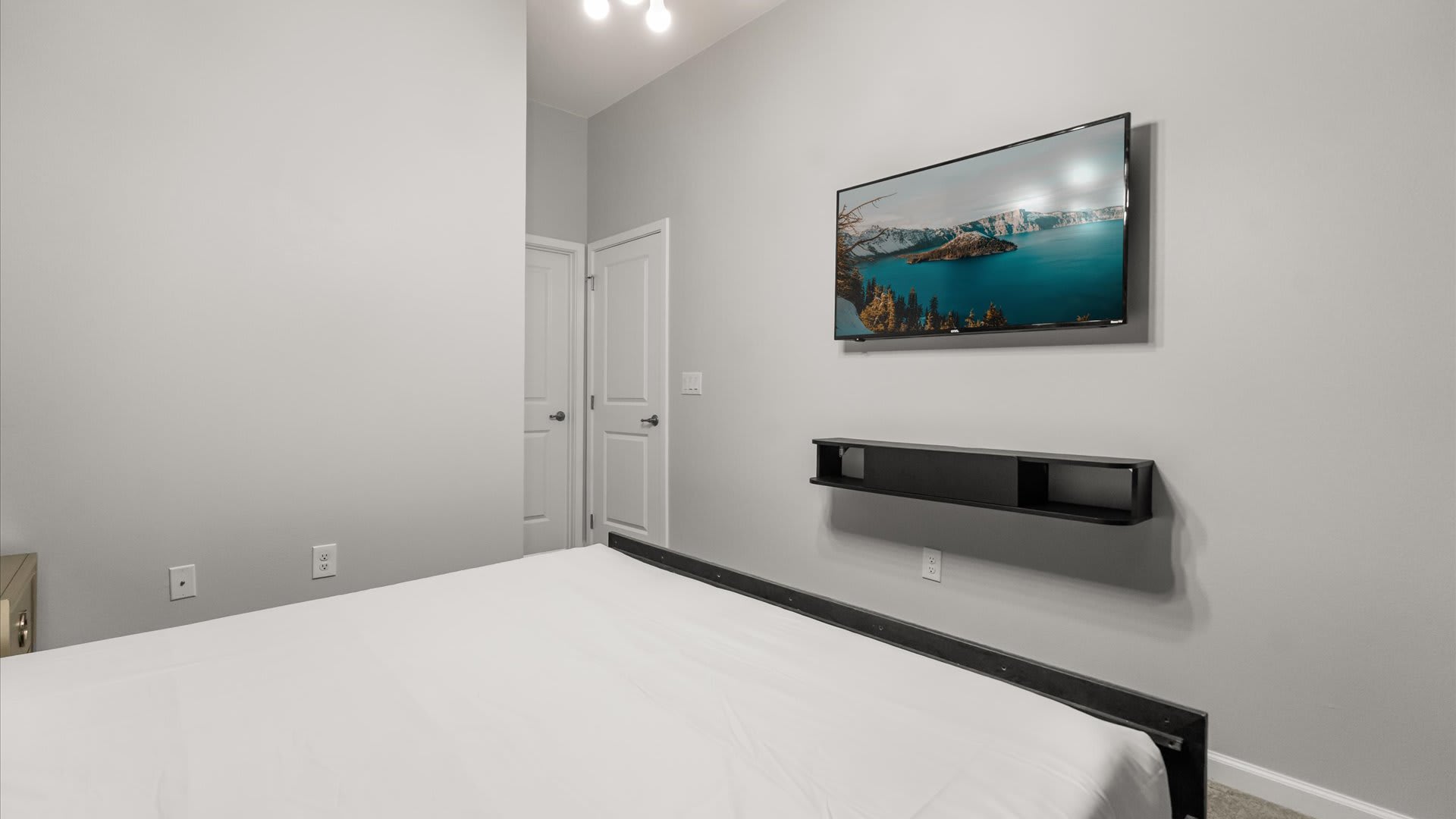 Bedroom 2 – Peaceful king suite with forest-inspired mural and soft lighting.