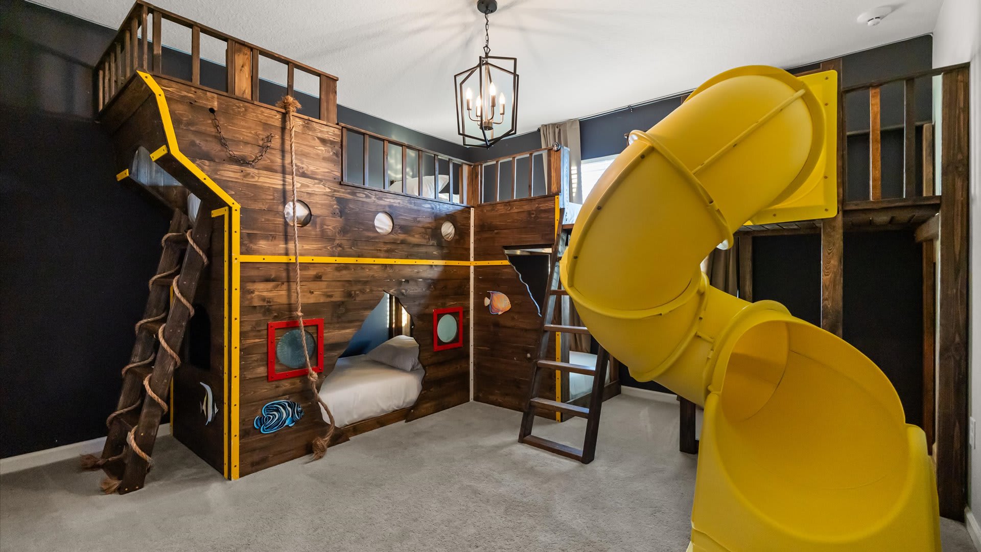 Kids’ adventure bedroom with indoor slide and climbing features — endless fun in a safe space.