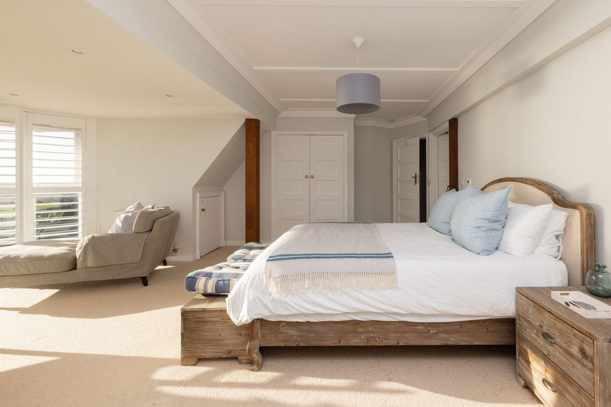 Spacious master bedroom with seating area.