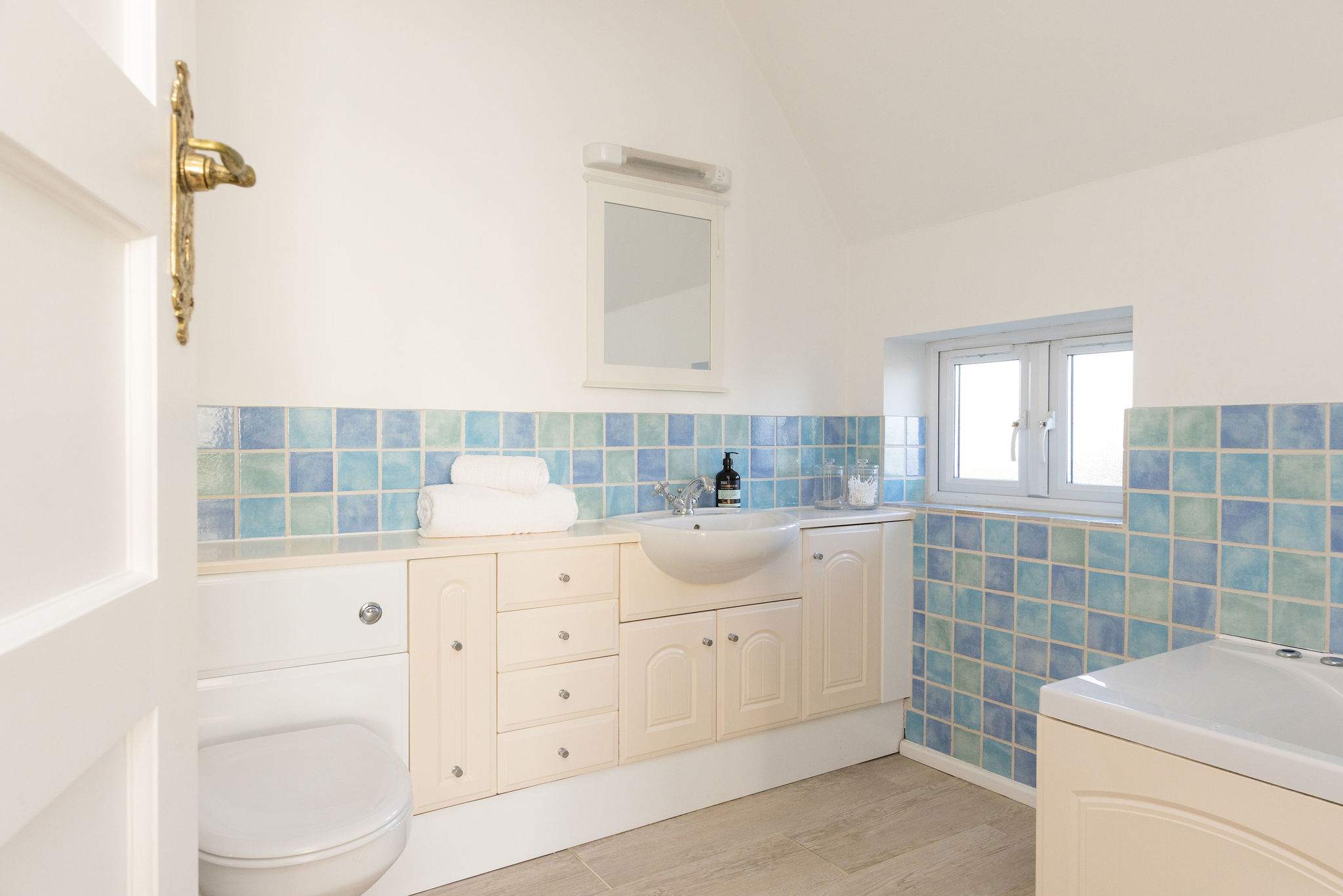 Family bathroom with bath & vanity unit.
