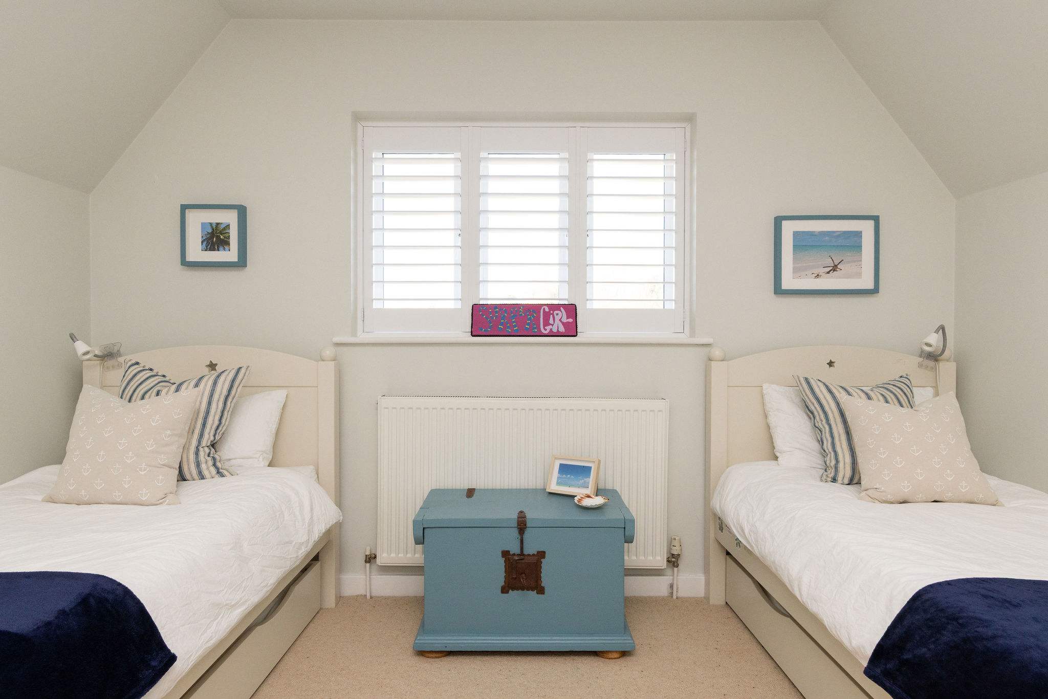 Bright twin bedroom with coastal charm.