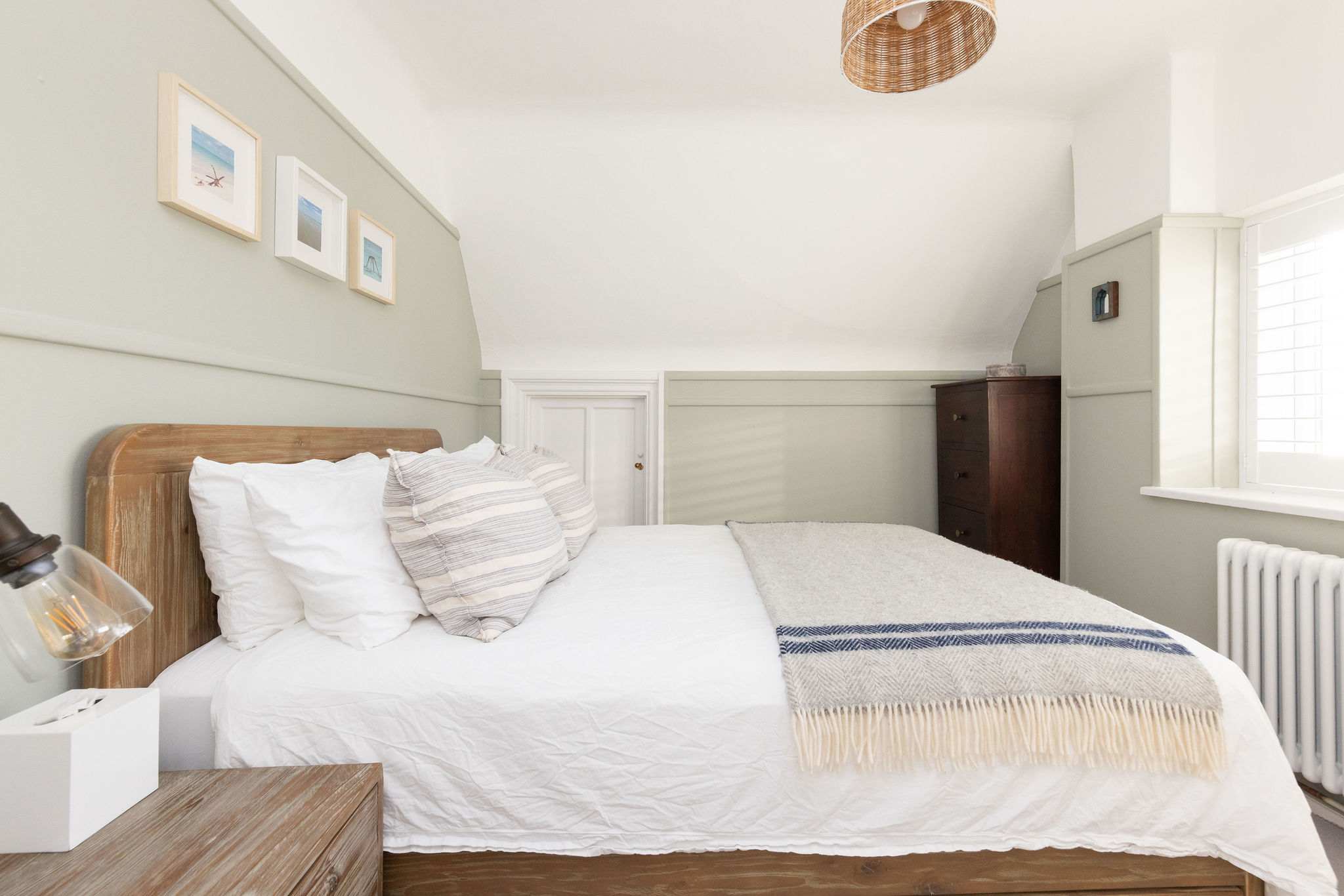 Cosy bedroom with stylish coastal decor.