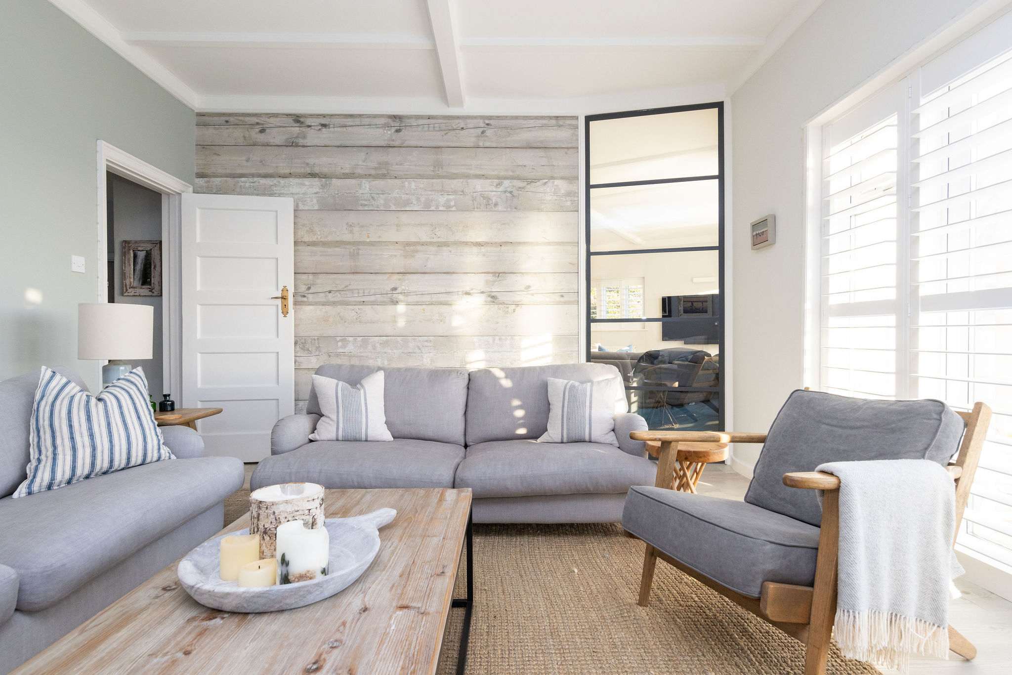 Sun-filled lounge with rustic coastal decor.