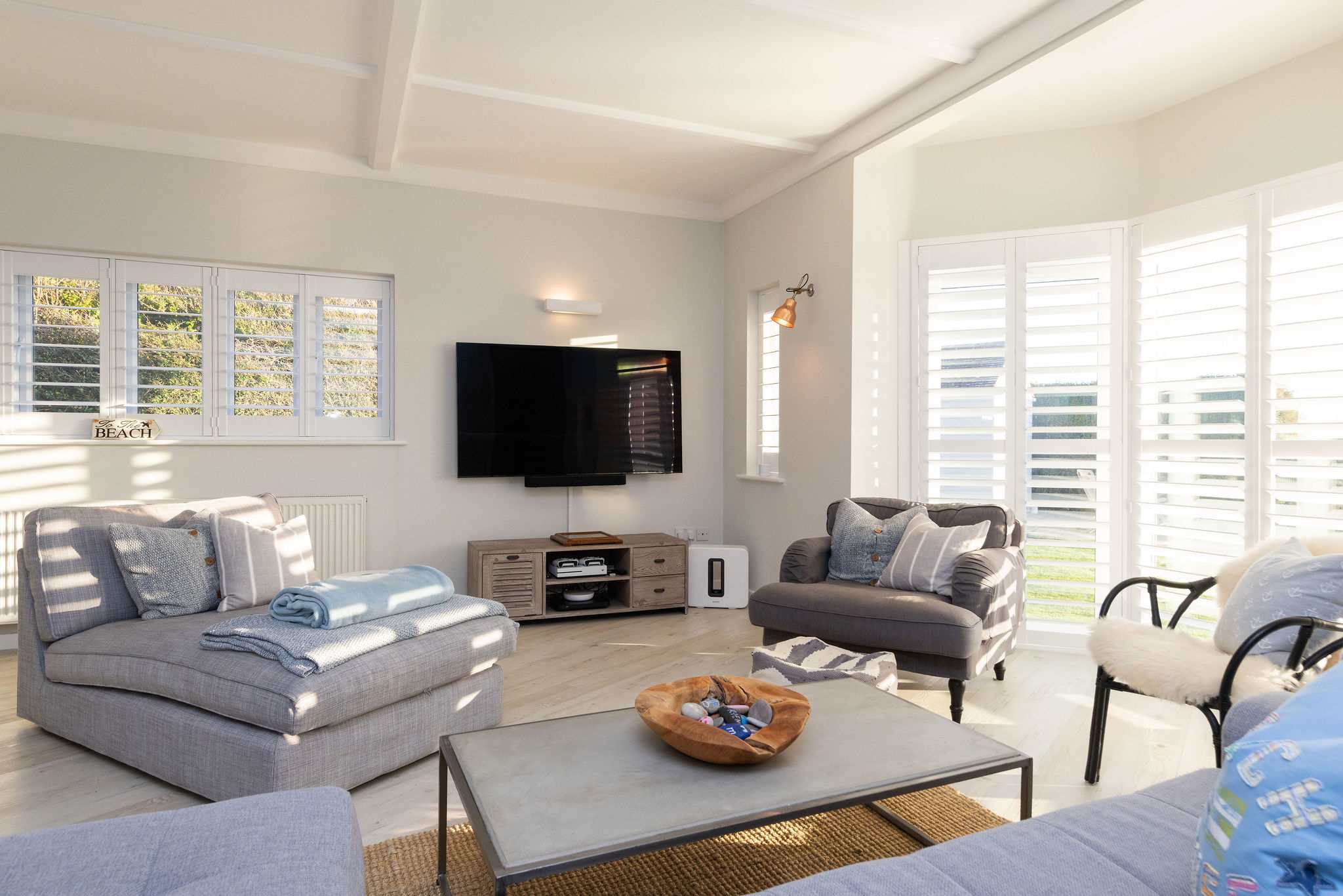 Bright & airy living room with bay windows.