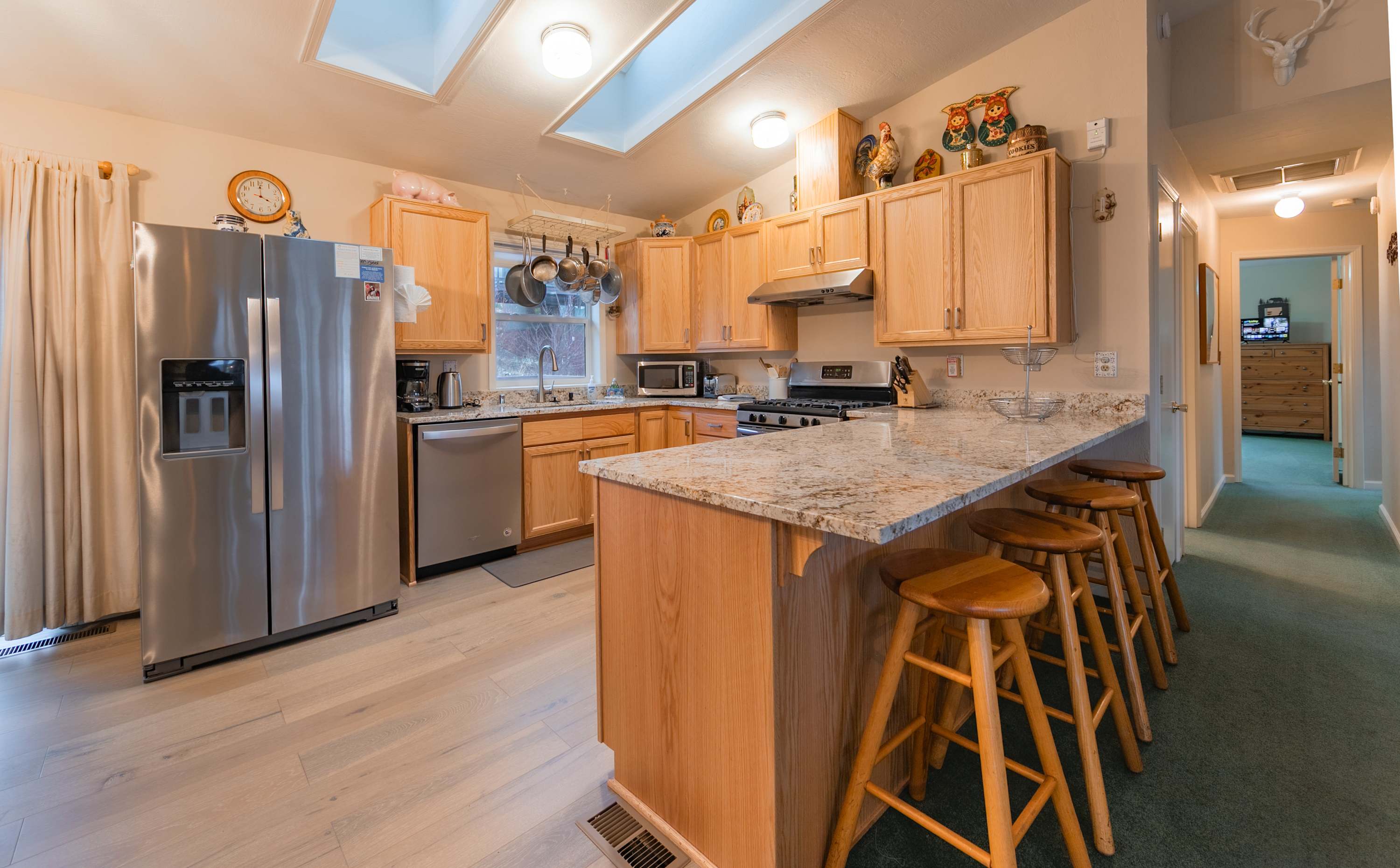 Updated kitchen with all the conveniences of home and breakfast bar seating. Skylights provided added natural light for a bright and spacious feel.