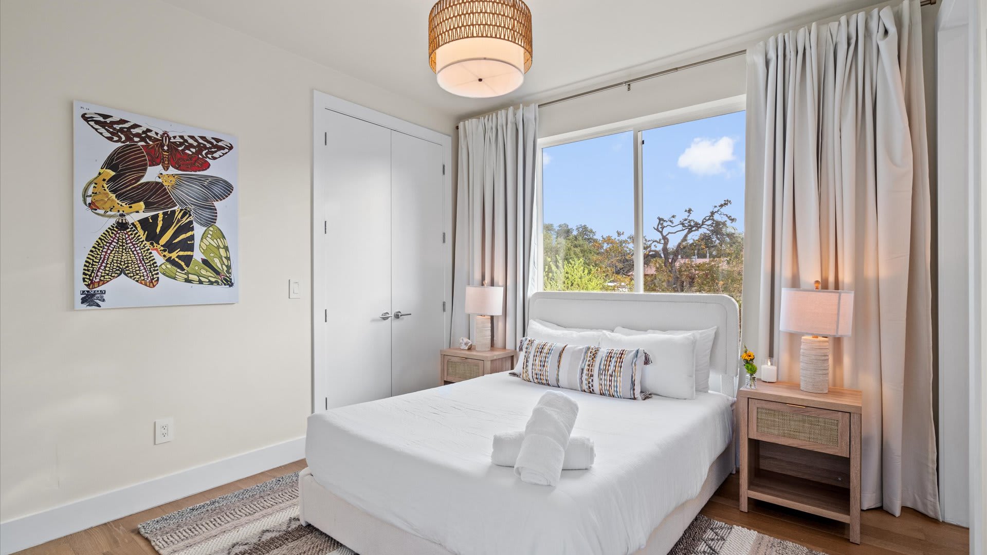 Bright queen bedroom with fresh linens 