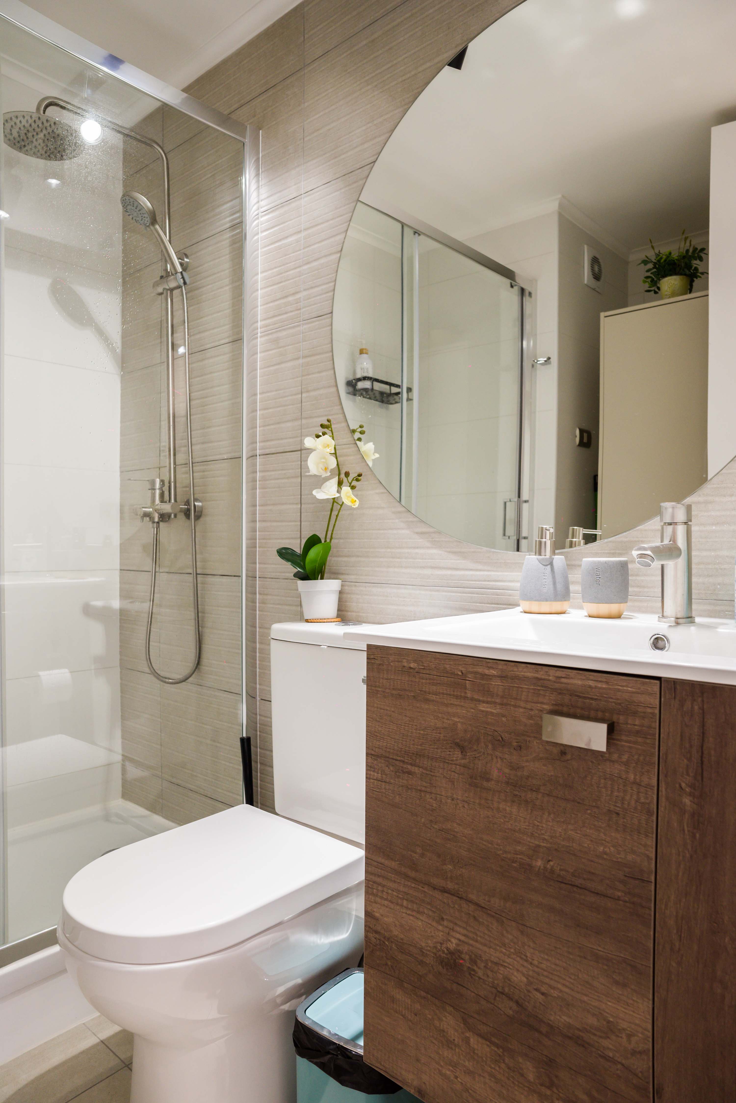 Modern bathroom with sleek fixtures and a spacious shower, perfect for a refreshing start to your day.