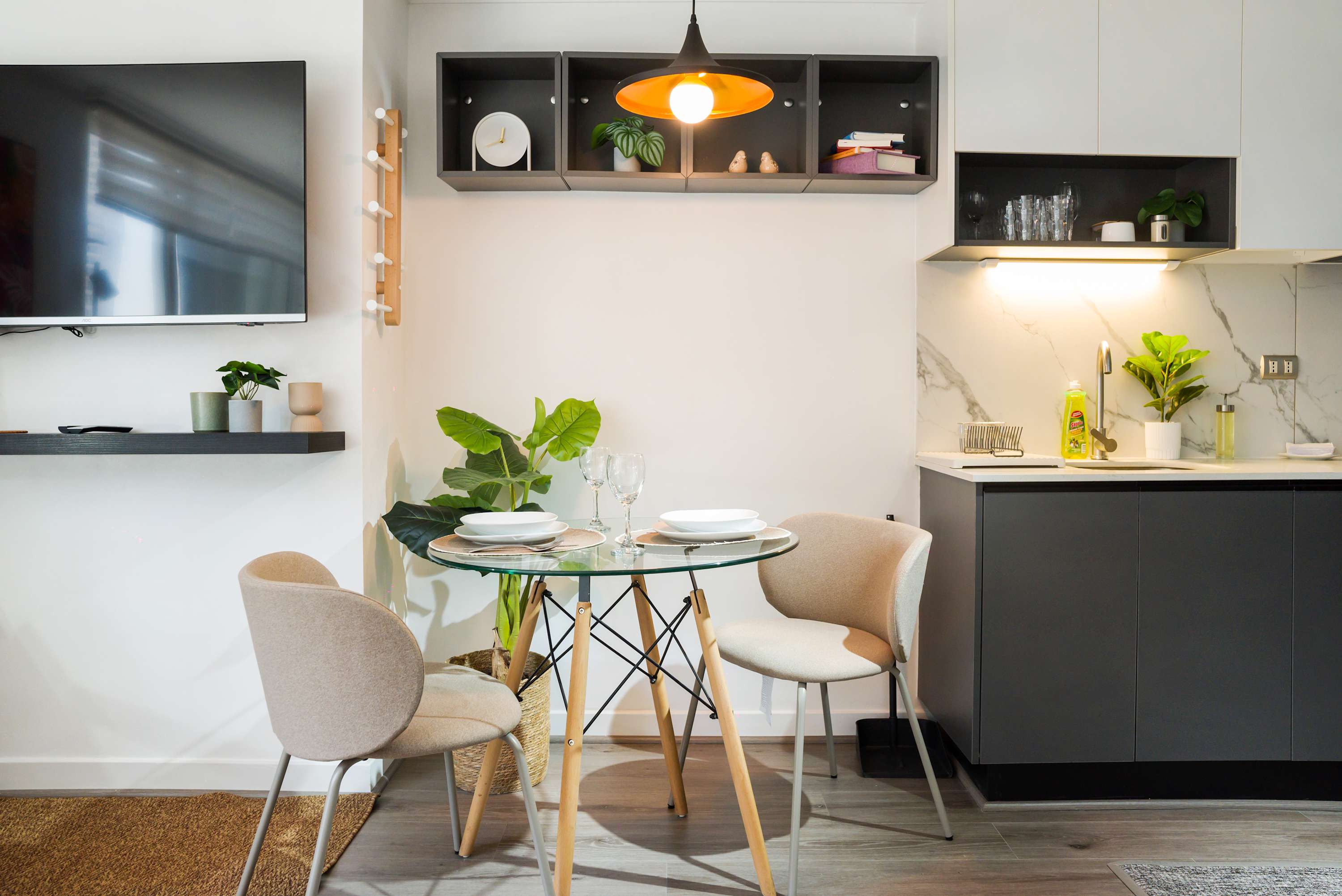 Chic dining nook with modern decor and a cozy atmosphere, perfect for intimate meals in your stylish studio retreat.