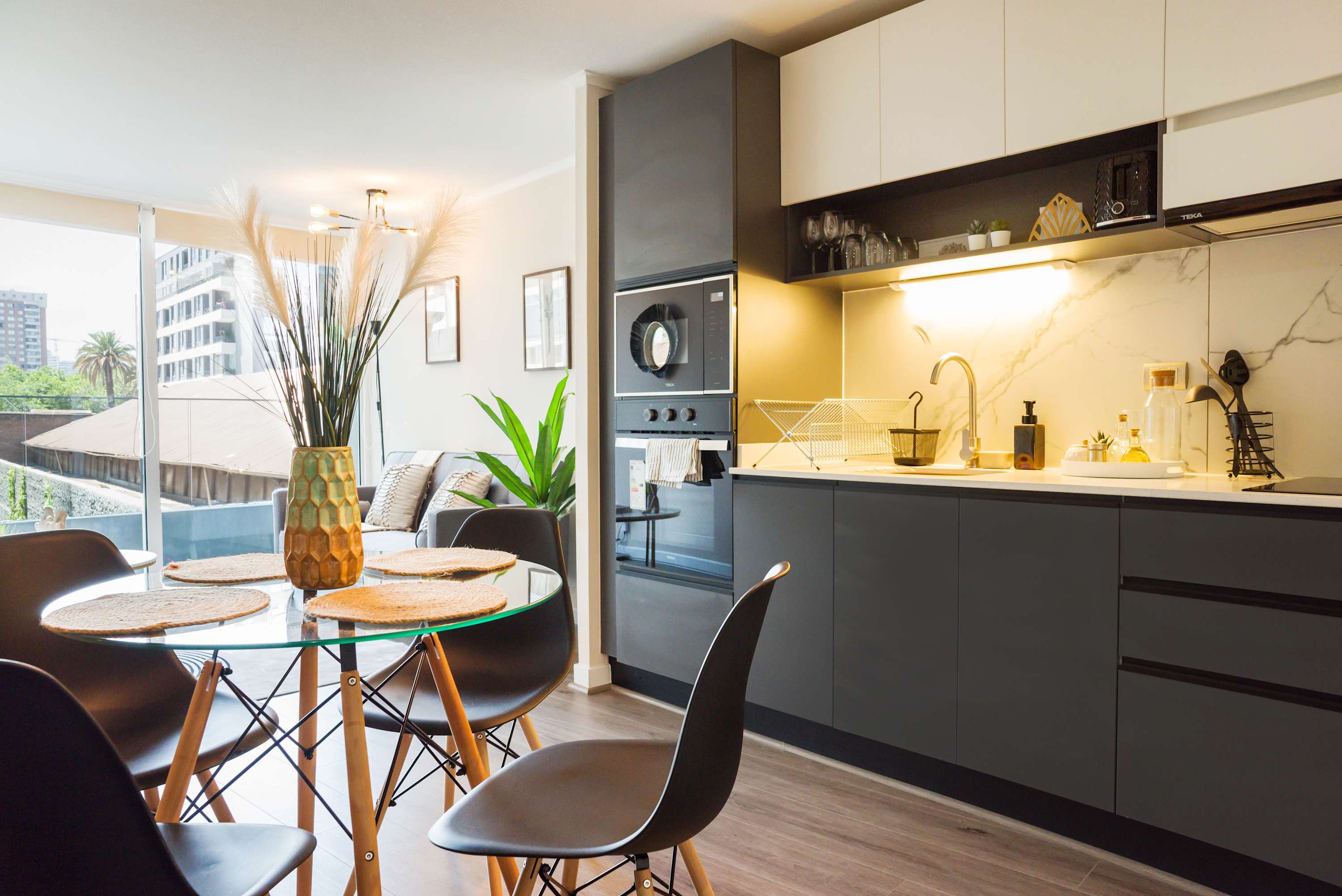 Stylish kitchen and dining area with modern amenities and abundant natural light, perfect for cozy meals.