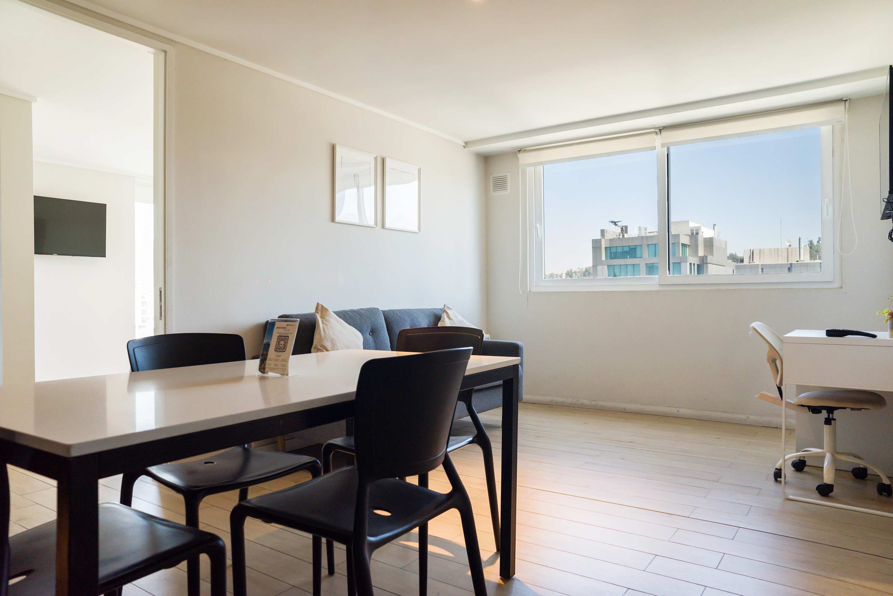 Bright and airy living space with city views, perfect for dining and remote work.