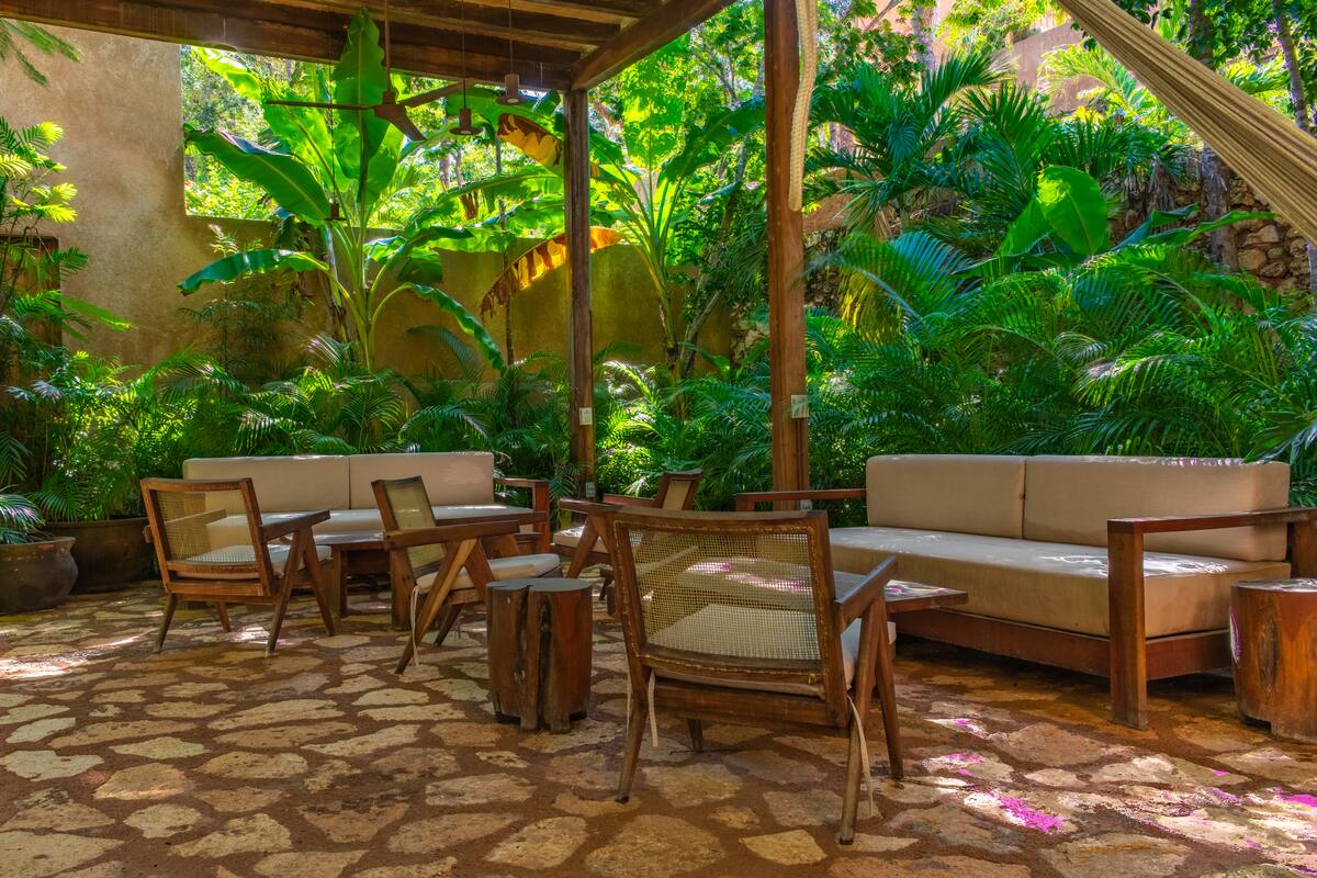 Communal garden overlooking the main shared pool, surrounded by lush greenery
