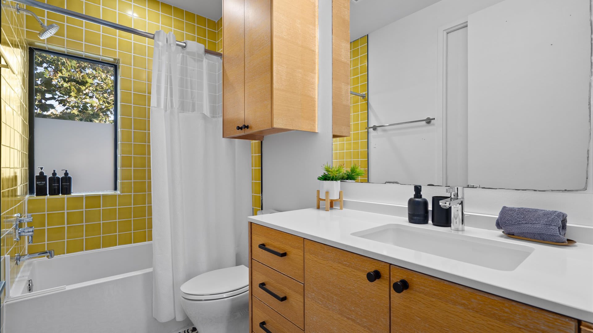 Stylish Bath With A Pop Of Color And Elegant Storage Space