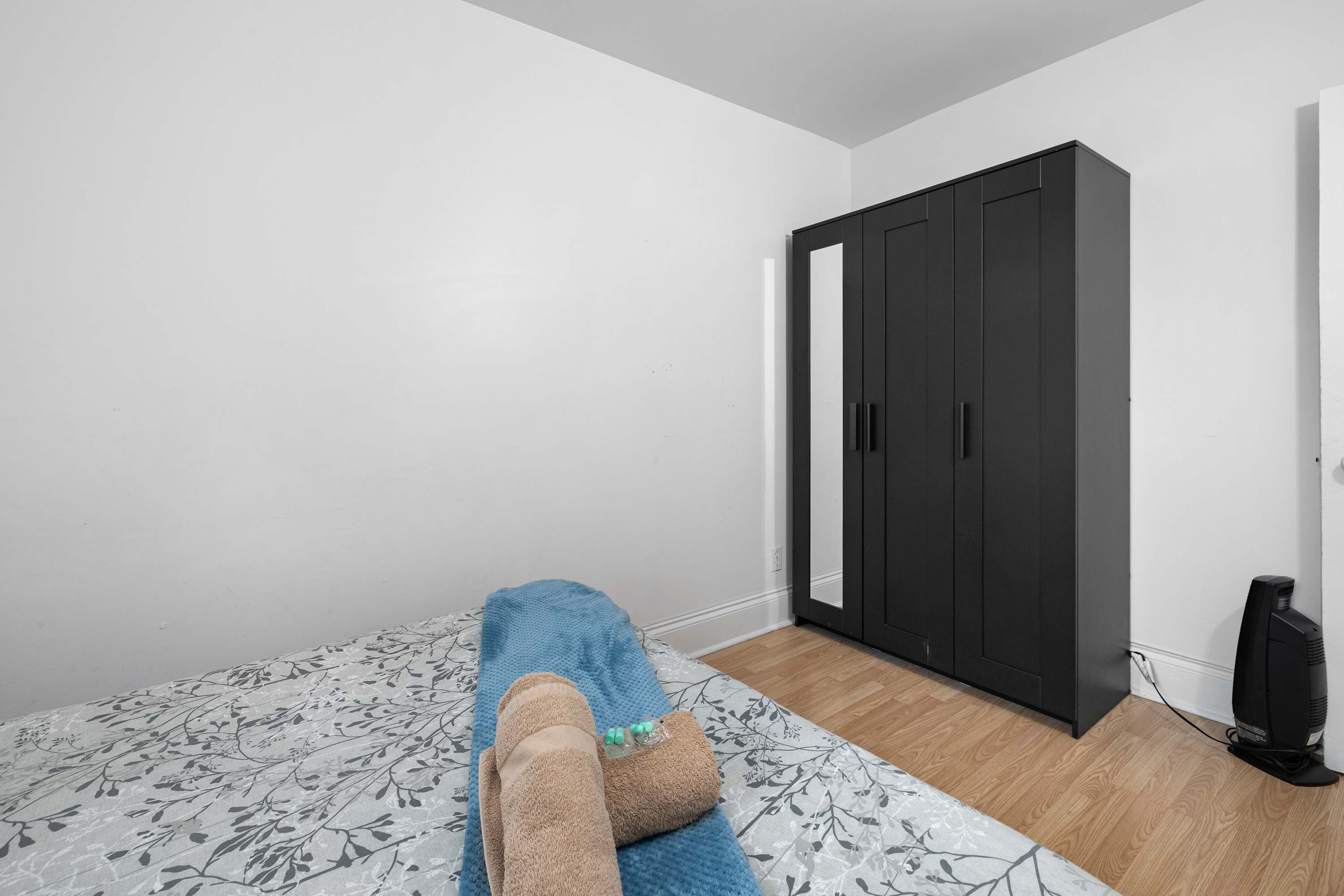 Queen bedroom with fresh linens and closet space.