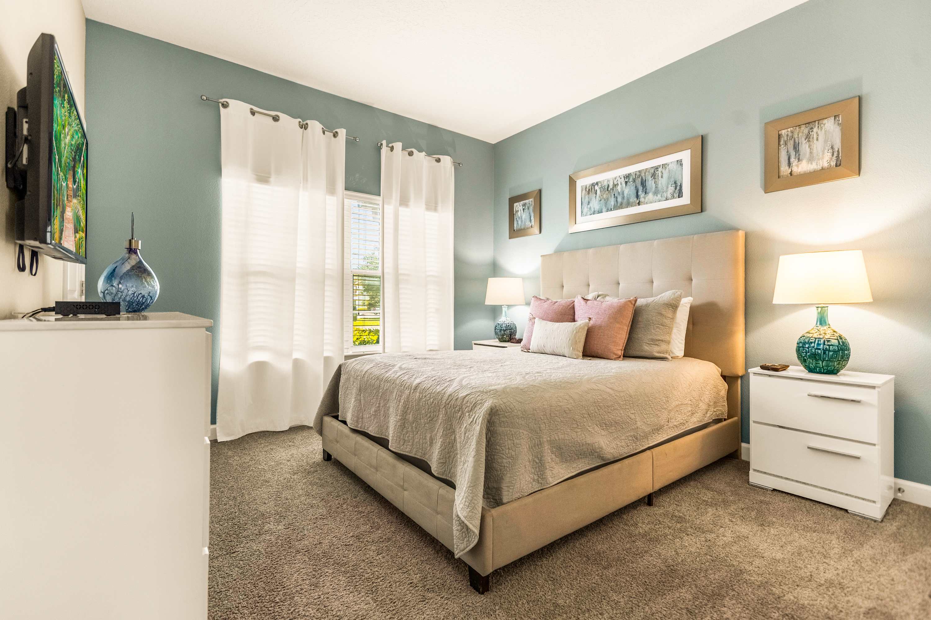 Relax in this serene bedroom with plush bedding and natural light, perfect for unwinding after a day of exploring.