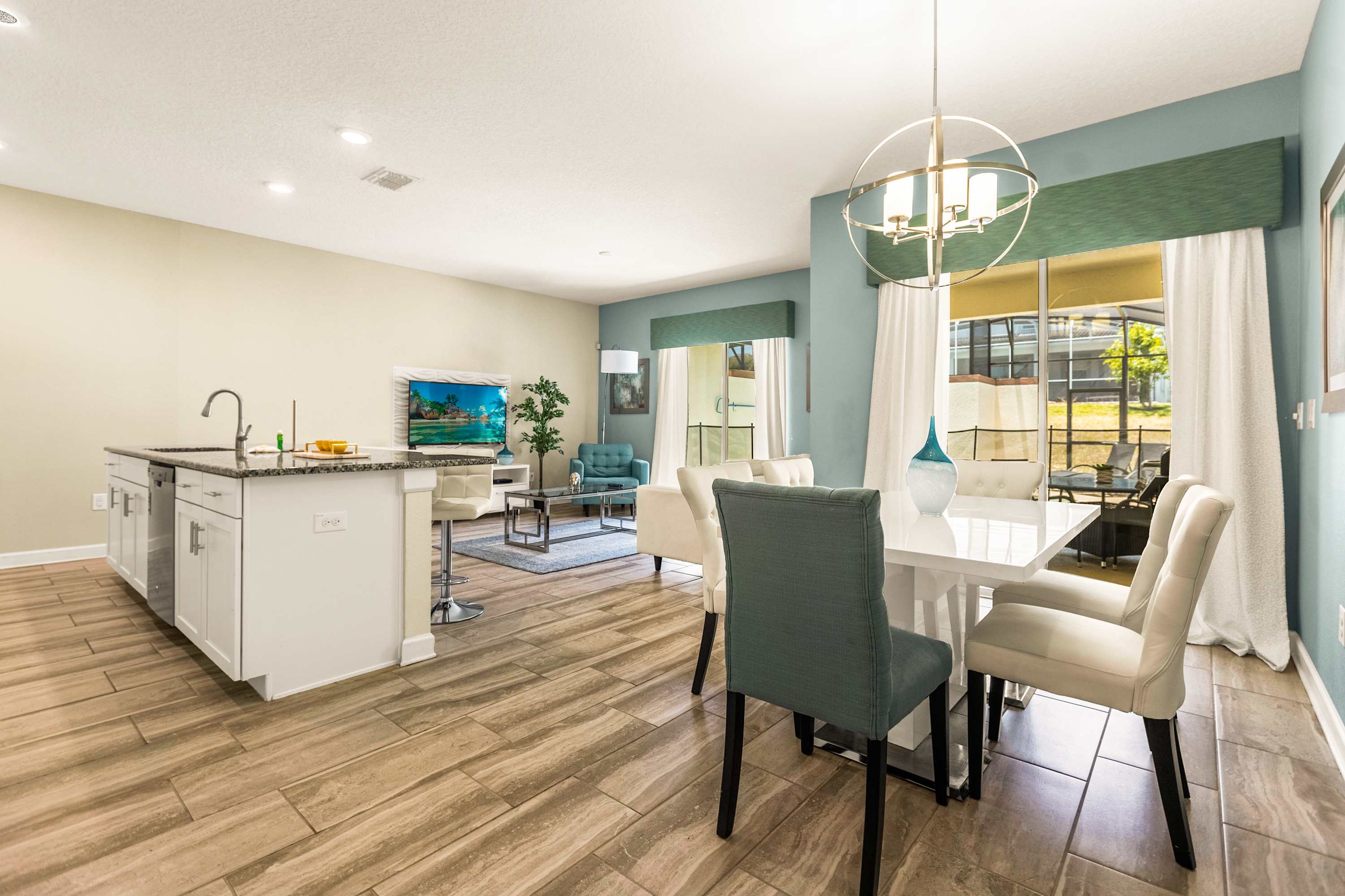 Spacious open-concept dining and living area with modern decor and ample natural light, perfect for family gatherings.