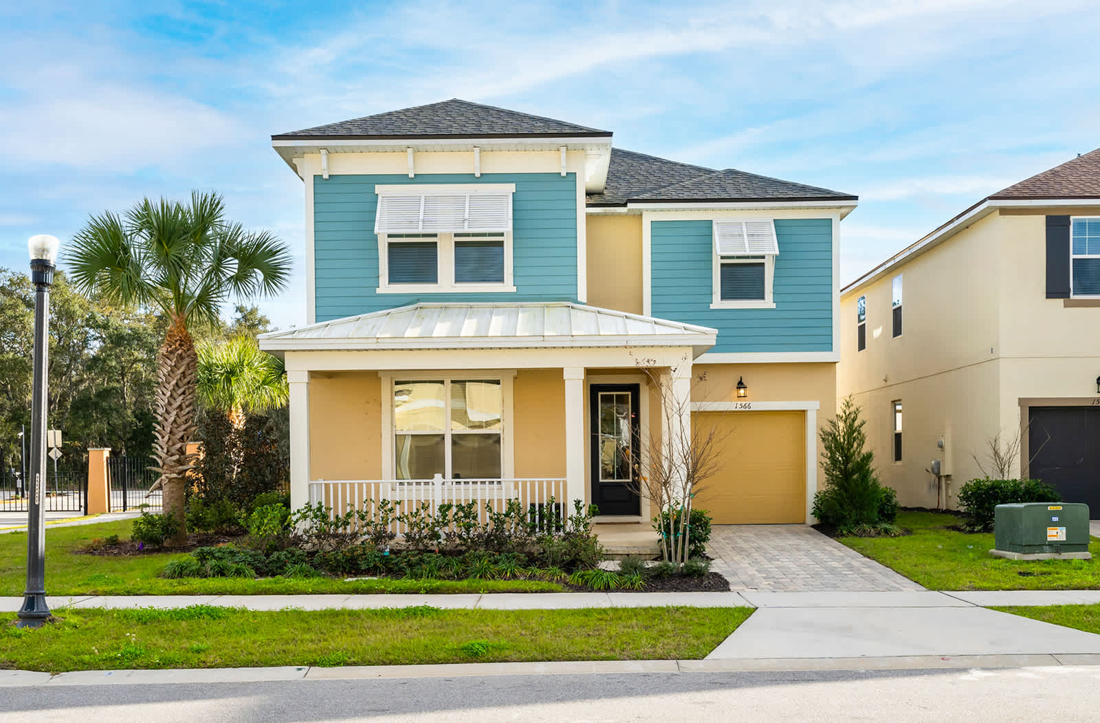 Charming two-story villa with a vibrant exterior and inviting porch, perfect for a relaxing getaway.